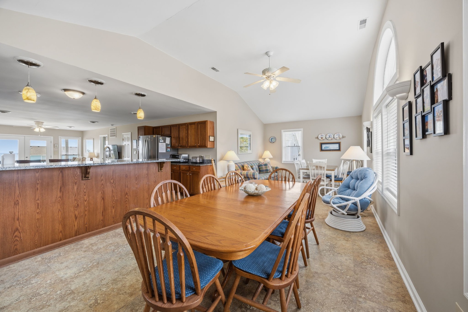 Gather your group around this spacious dining table where warm wood tones and natural light create the perfect setting for memorable meals together.