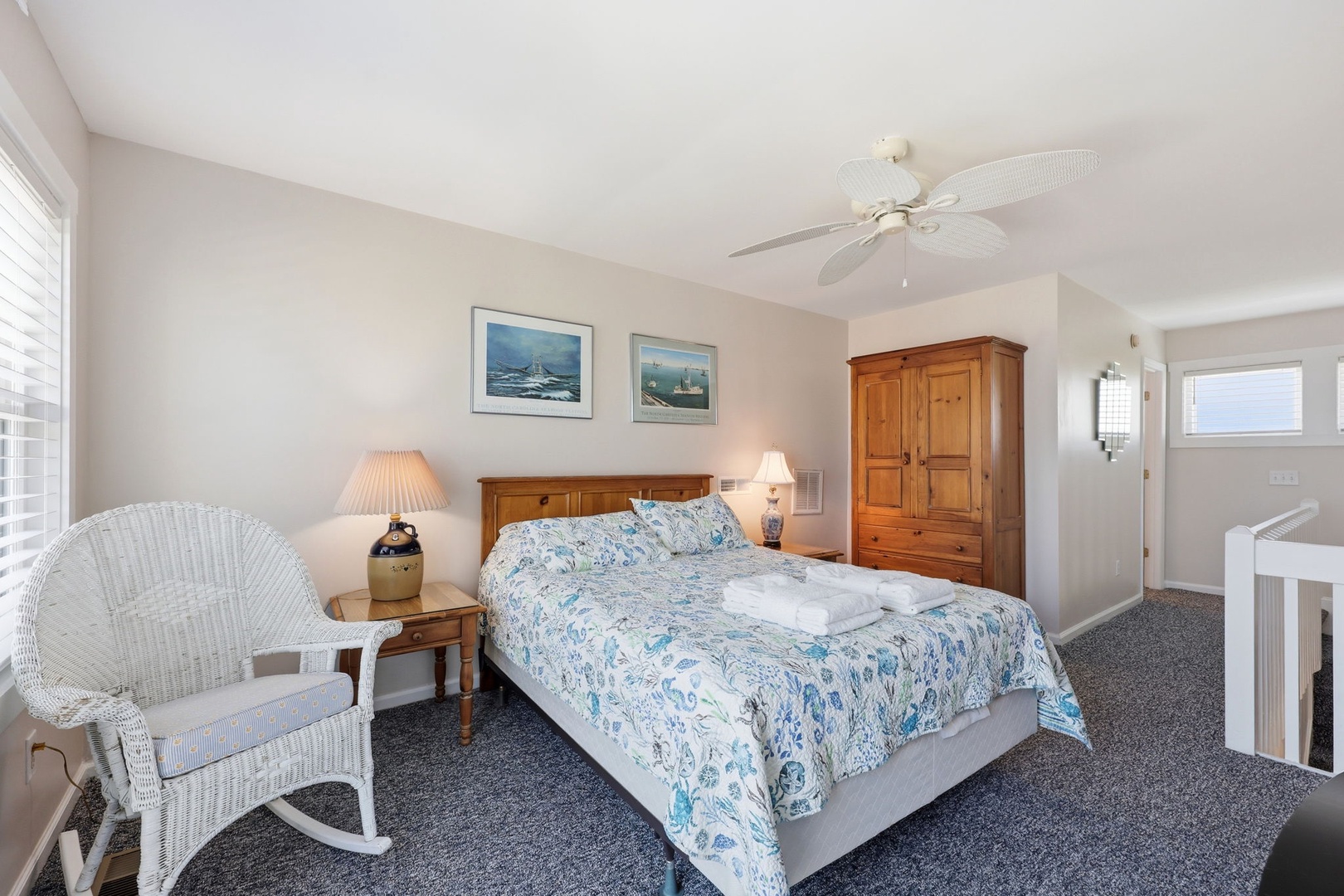Drift off in this serene bedroom with coastal charm, fresh linens awaiting your arrival, and a ceiling fan to keep you cool. Your perfect retreat for restful nights by the shore.