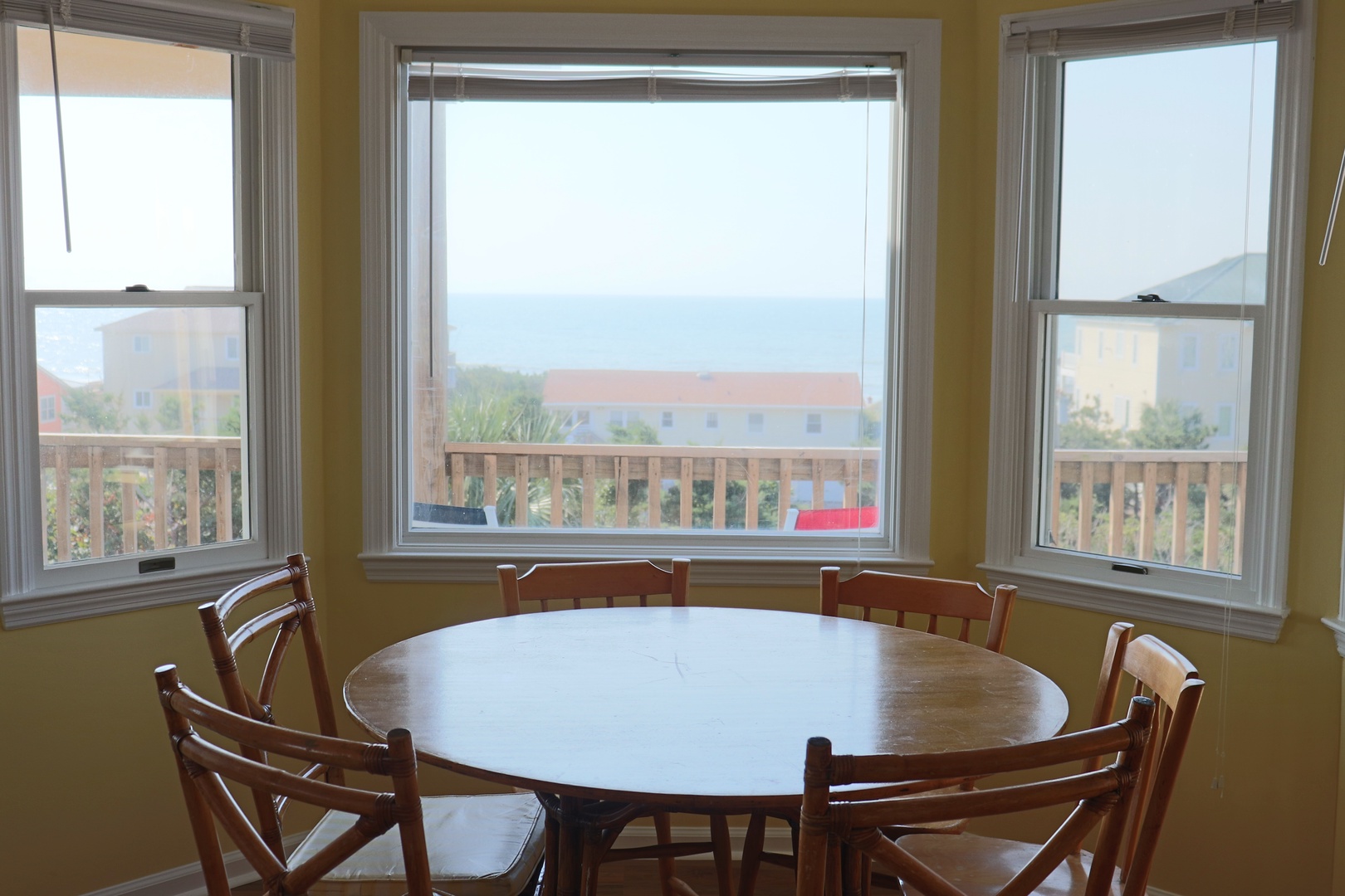 Gather around this sunny dining nook where your morning coffee tastes better with ocean glimpses through the bay window.