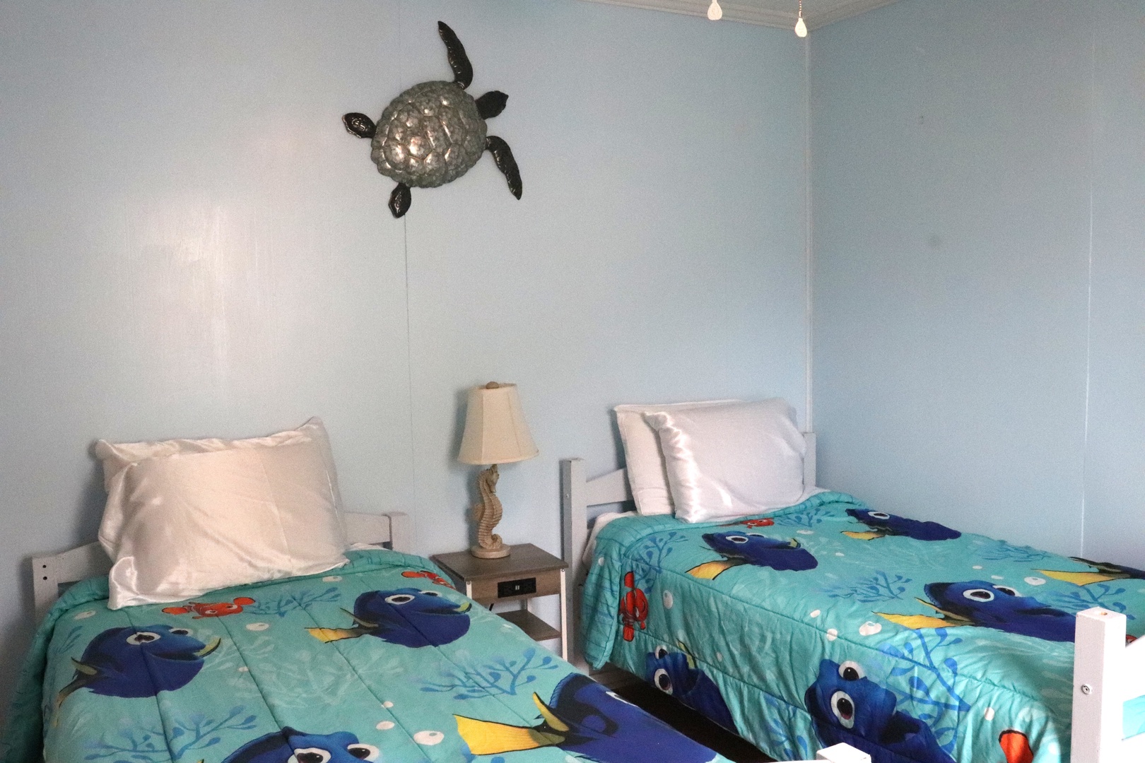 Your little ones will love this ocean-themed room with two comfy twin beds and cheerful sea turtle décor that makes bedtime an adventure.