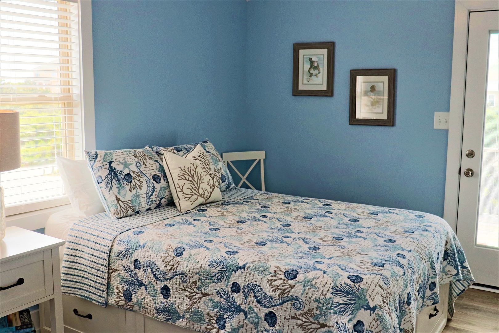 Wake up in your coastal-themed bedroom where soft blue walls and seashell bedding create a peaceful seaside retreat.