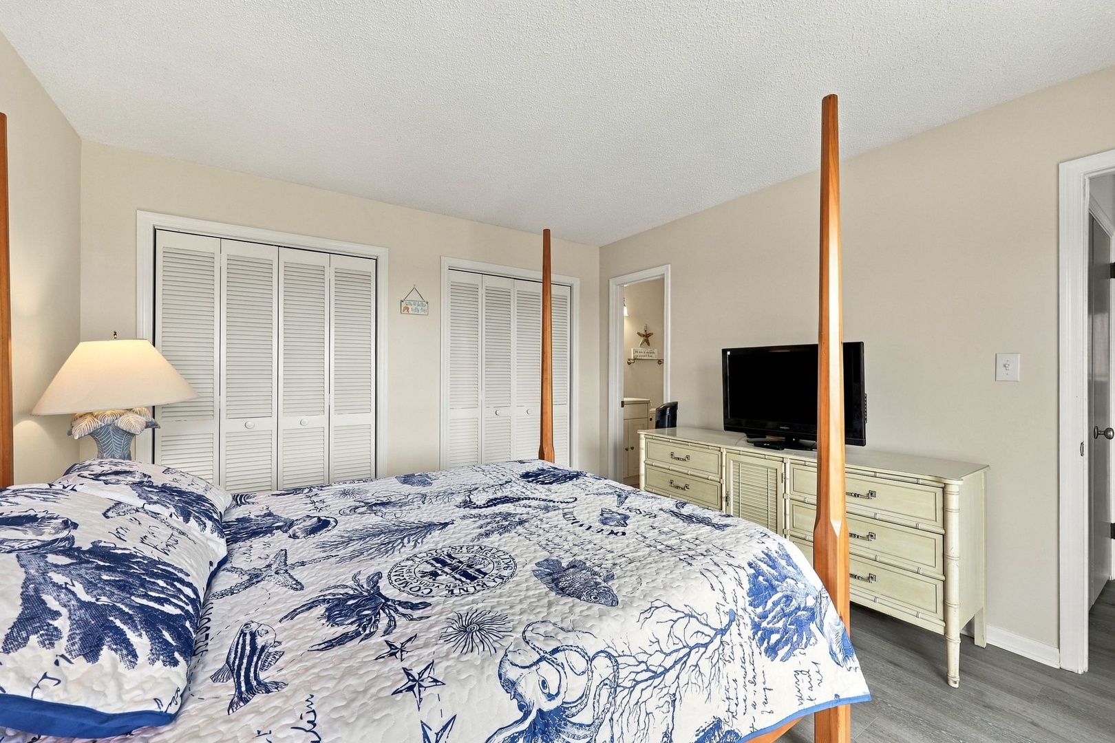 Sink into coastal comfort on your inviting bed, surrounded by soft nautical touches and plenty of storage space. The room's gentle neutral tones and natural light create a peaceful retreat where you can truly unwind.