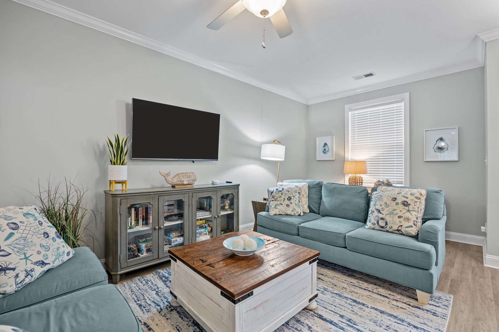 Sink into plush seating with cozy throws while your favorite shows play on the wall-mounted TV in this serene living space.