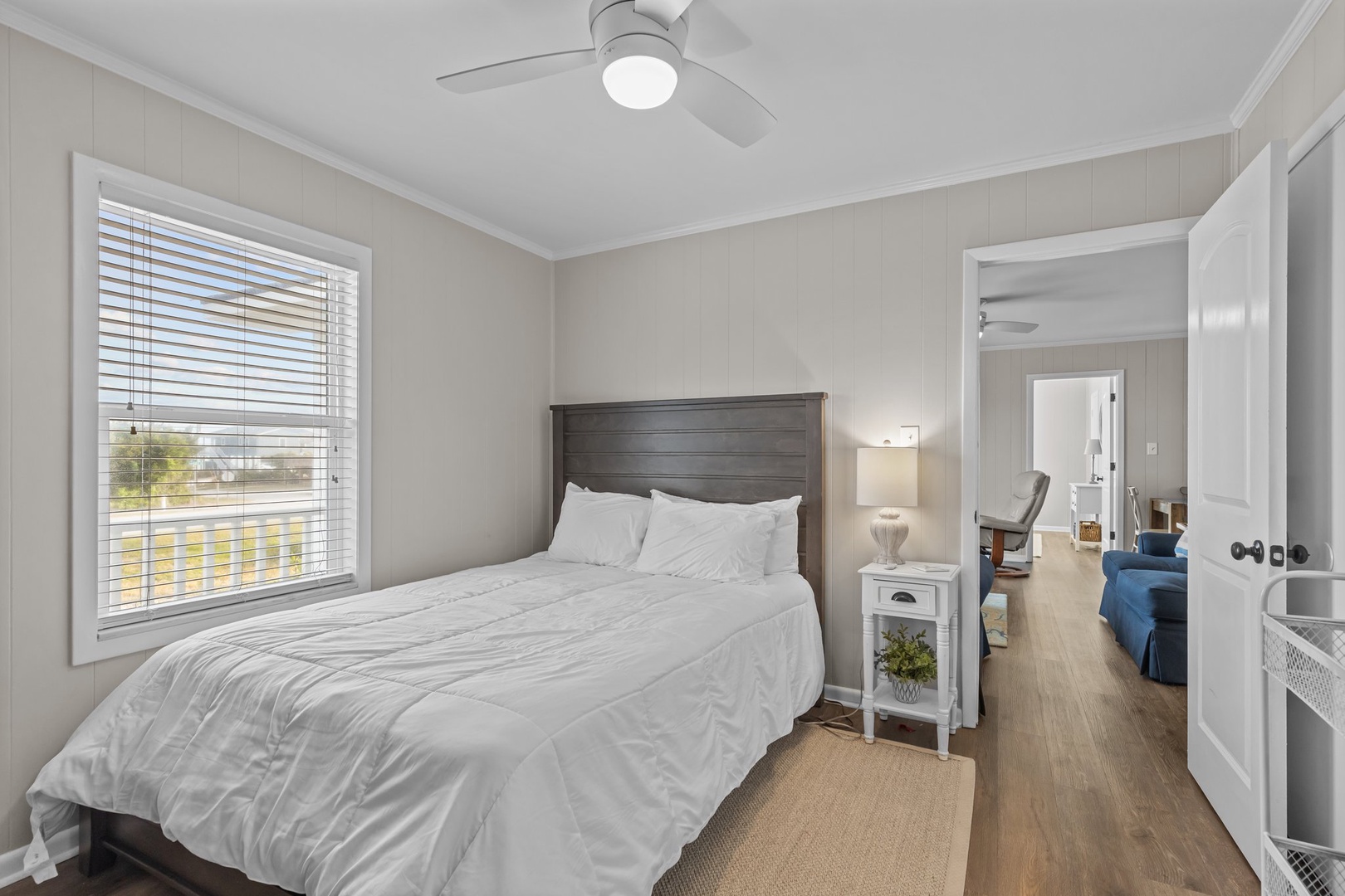 Your peaceful bedroom retreat features crisp white linens and a gentle ceiling fan to keep you cool and comfortable throughout your stay.