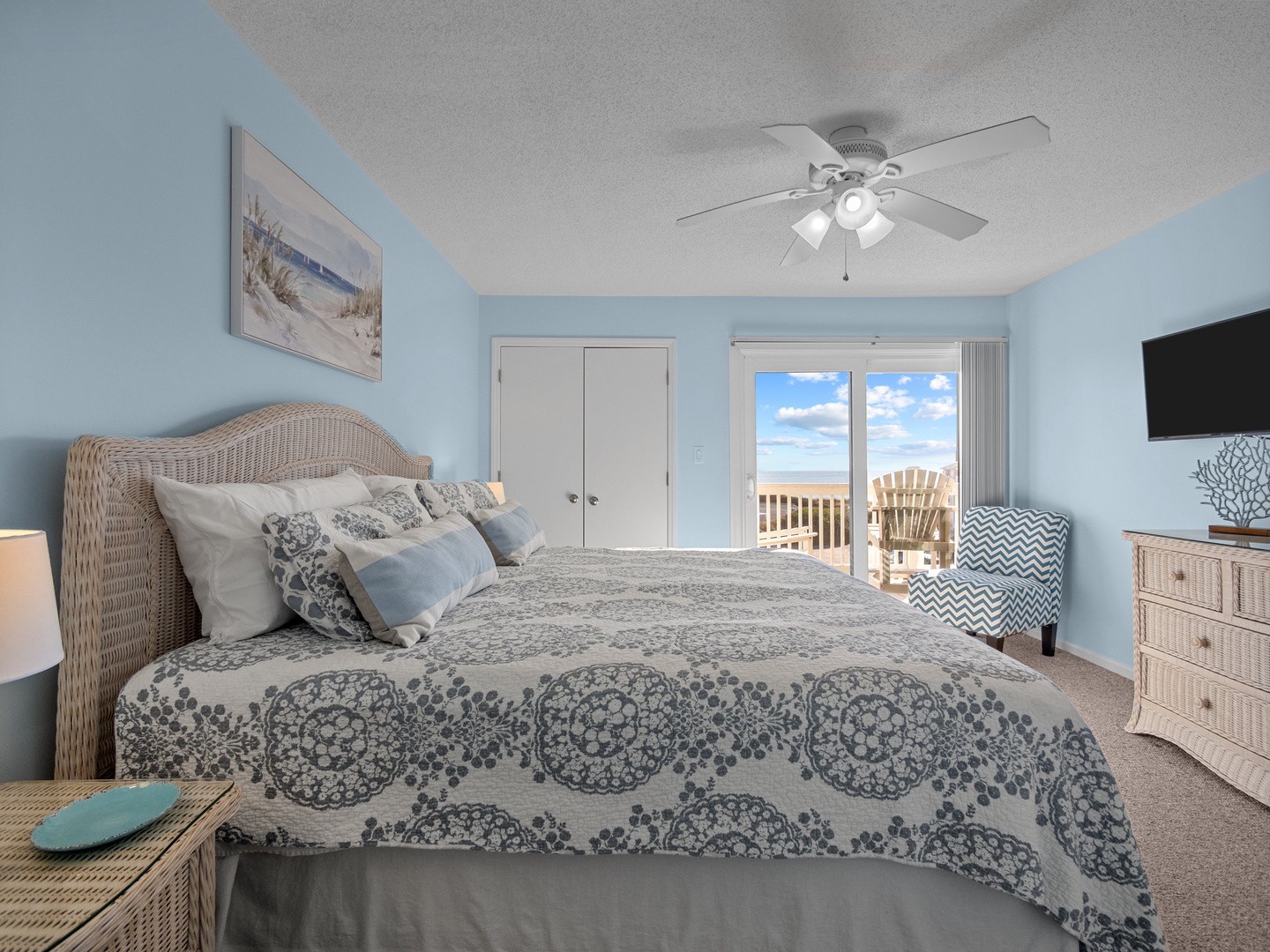 Drift off to peaceful sleep in your coastal-themed bedroom with soft blue walls and comfortable furnishings.