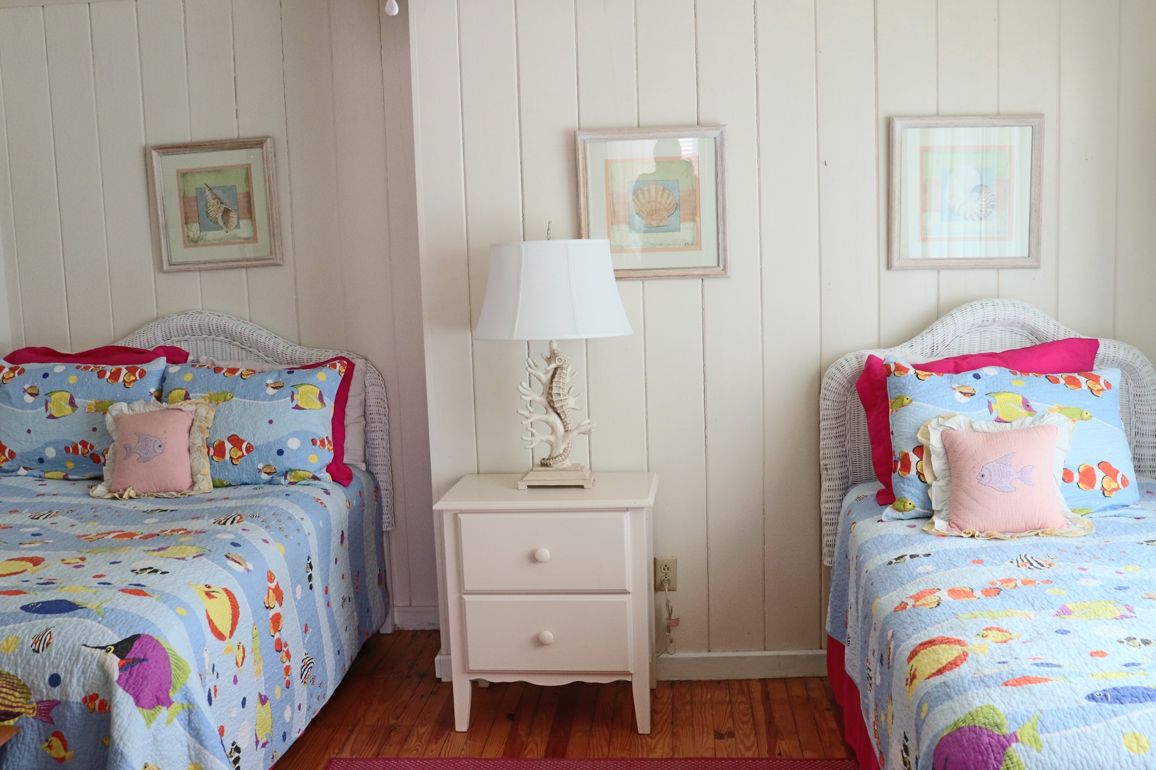 Drift off to sleep surrounded by cheerful ocean-themed bedding and coastal artwork in your cozy twin bedroom retreat.
