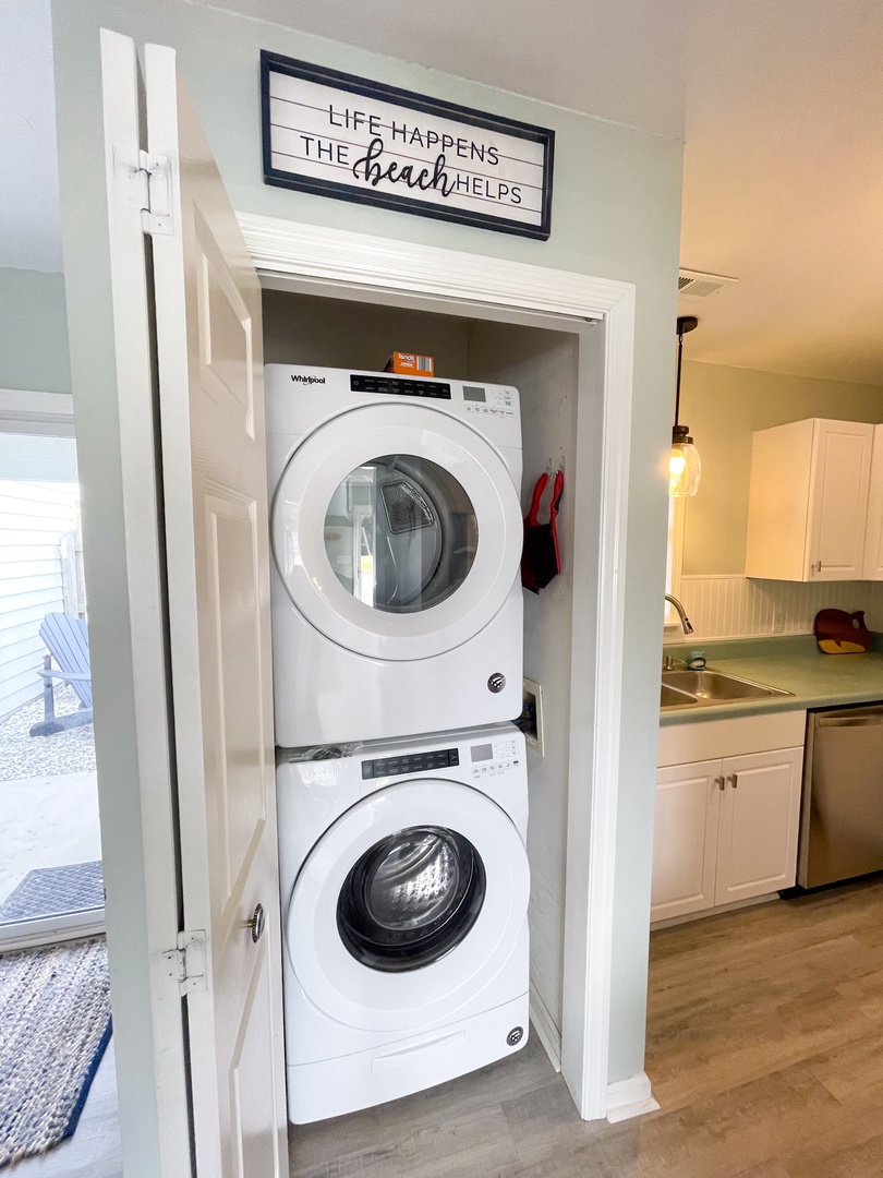 Your beach-themed laundry nook makes post-beach cleanup a breeze with stacked washer and dryer tucked beautifully into this coastal space.