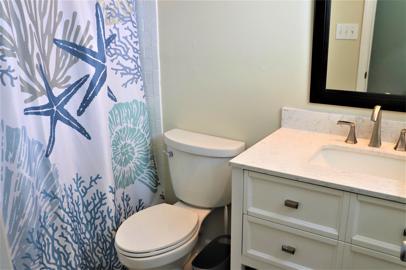 Step into your private coastal retreat with marble vanity, ocean-themed décor, and thoughtful touches that bring seaside serenity to your stay.