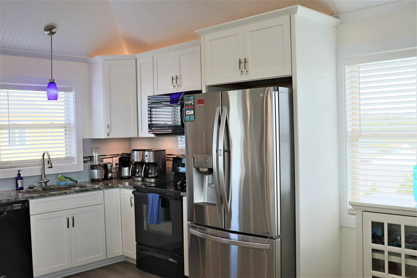 Your bright, modern kitchen features stainless steel appliances and crisp white cabinetry, perfect for preparing memorable vacation meals together.