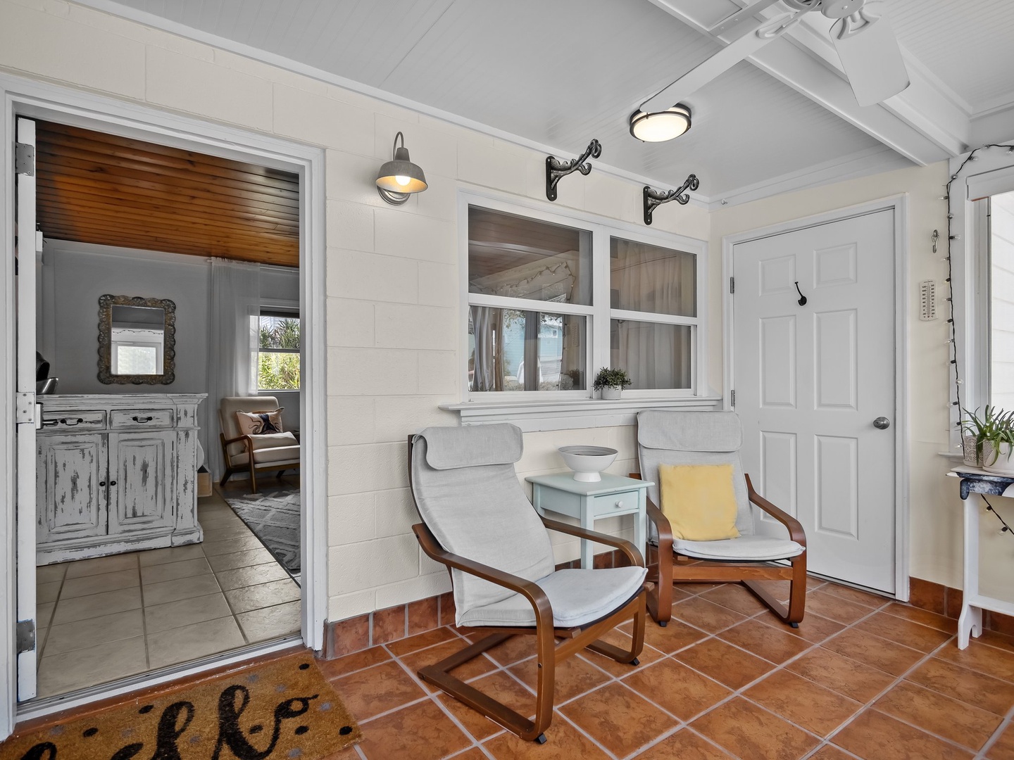Unwind in your private sunroom with comfortable seating and warm natural light streaming through windows.
