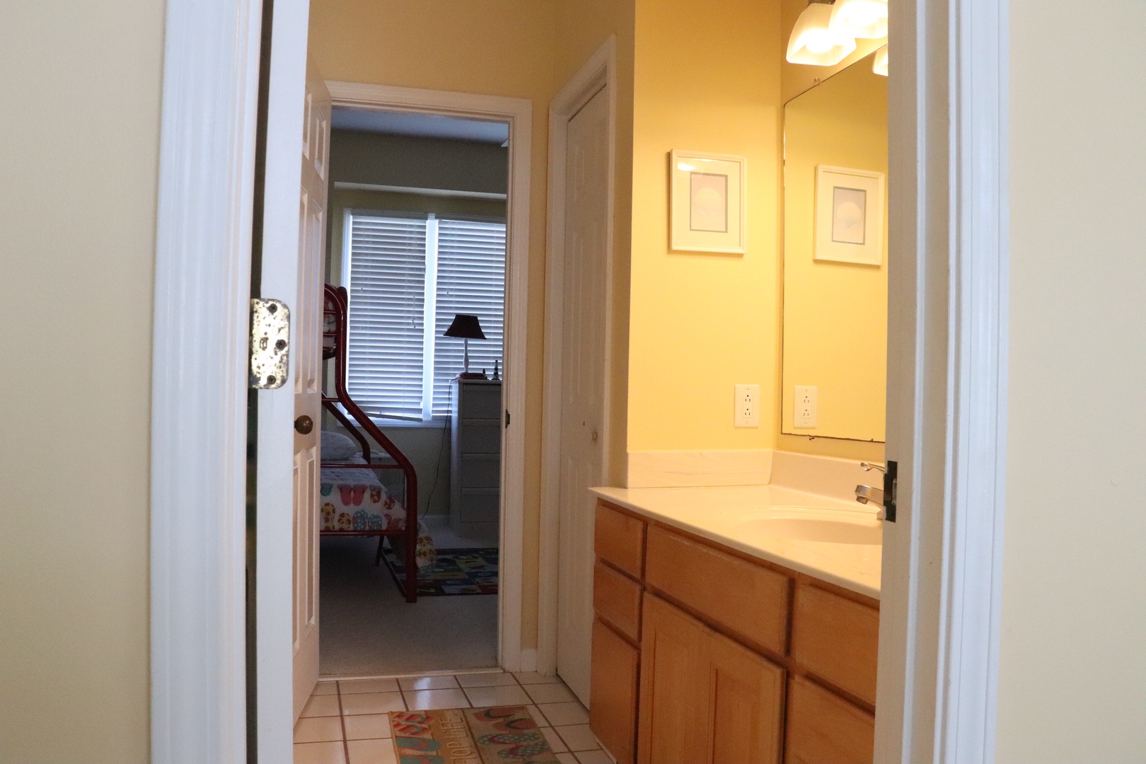 Step into your private bathroom with warm vanity lighting and ample counter space for your morning routine.