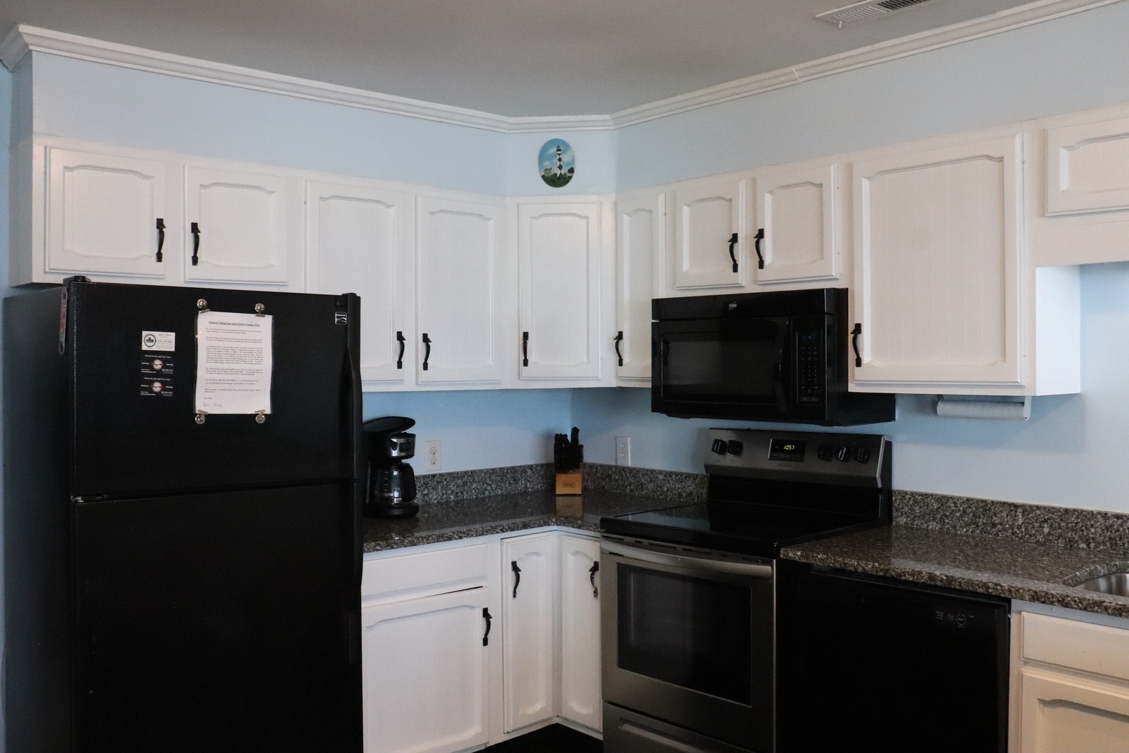 Your full kitchen features granite countertops, white cabinetry, and all the appliances you need to whip up a delicious home-cooked meal during your stay.