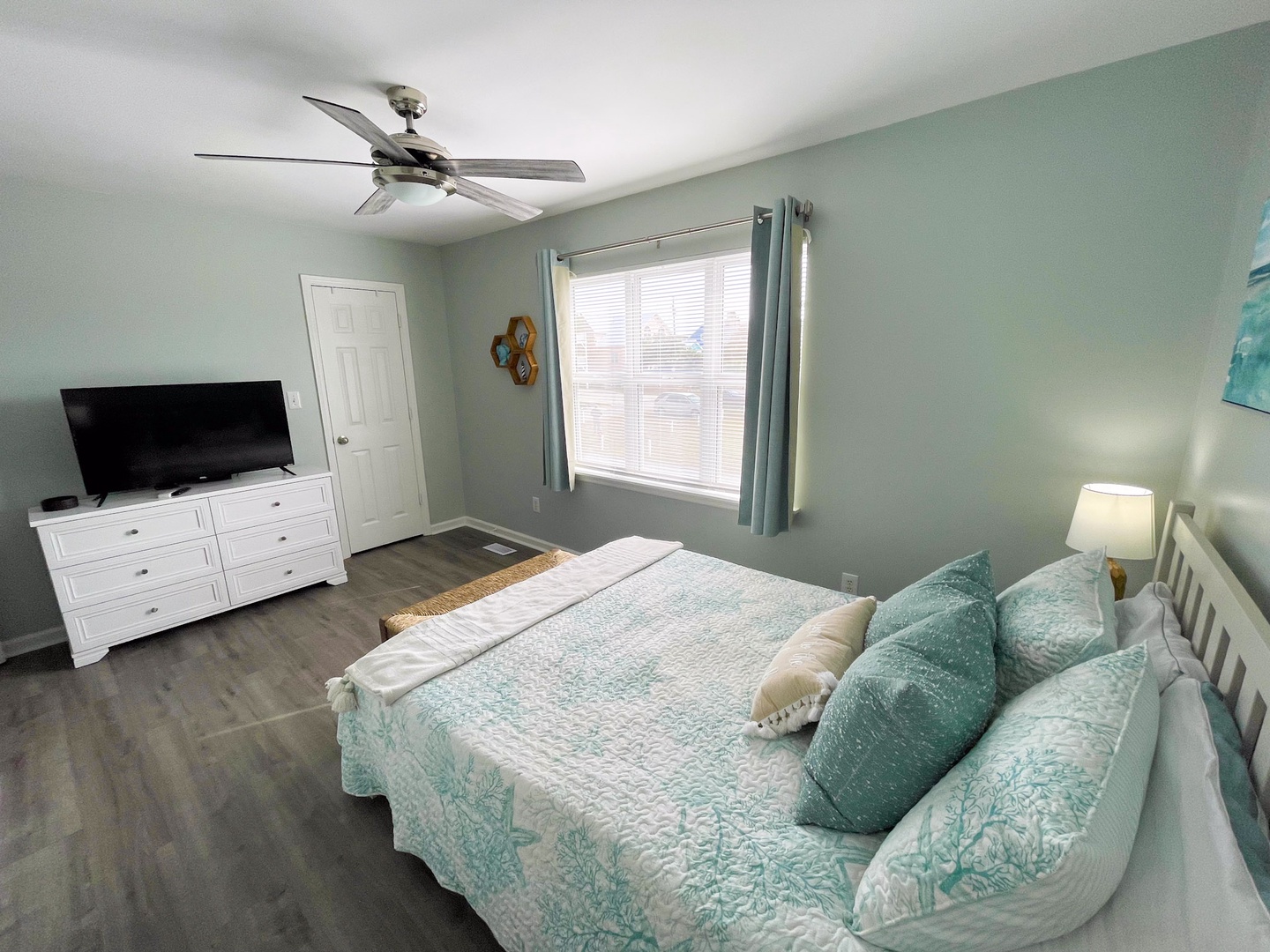 Drift off in your coastal-inspired bedroom, where soft aqua hues and crisp white linens create the perfect seaside sanctuary.