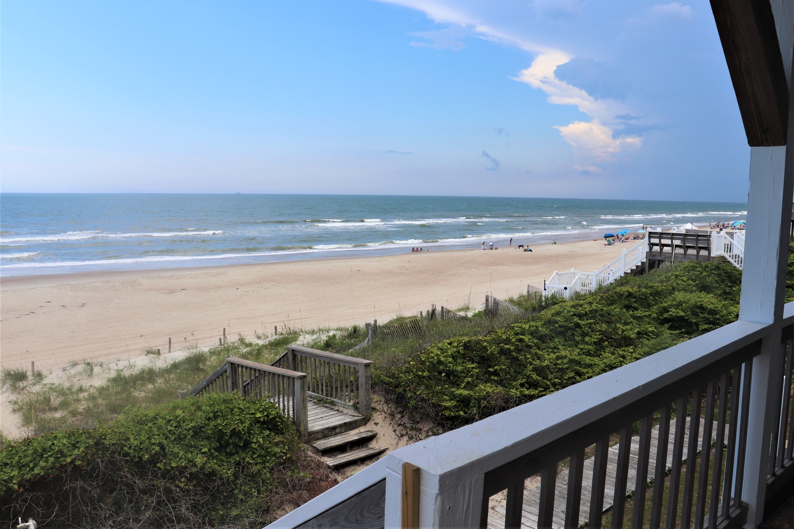 Stunning beachfront view from this coastal property shows sandy shores and ocean waves.
