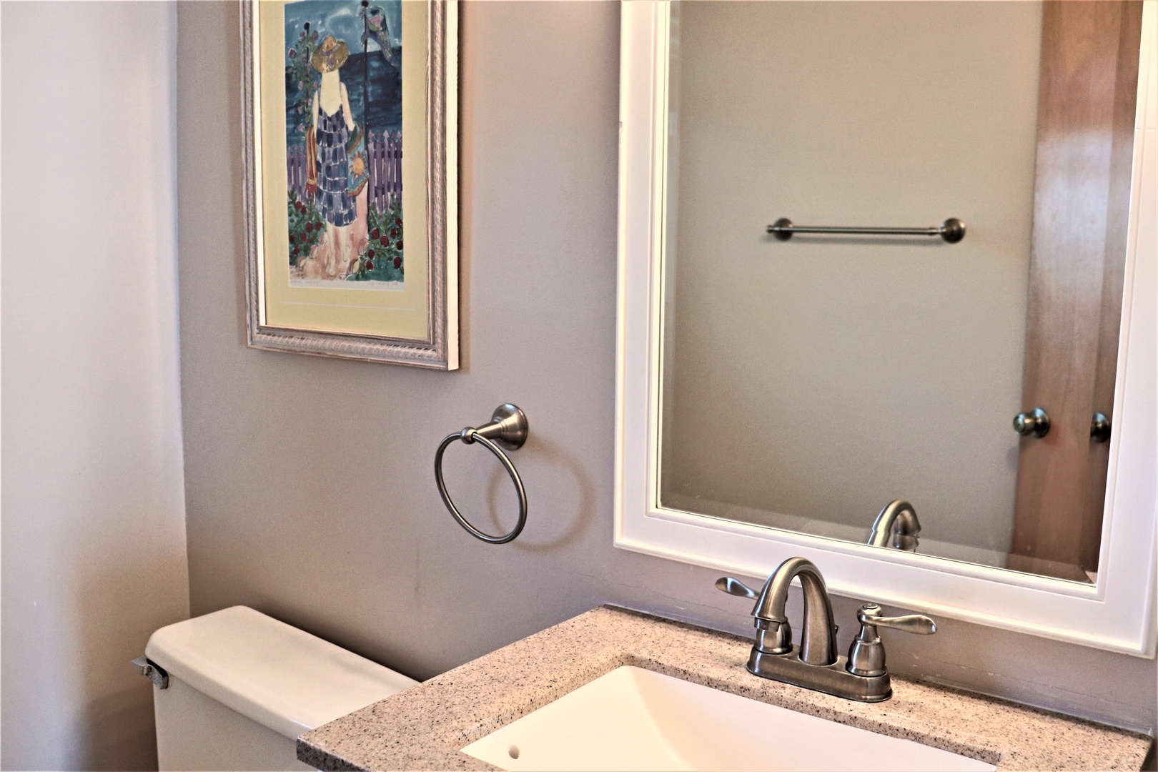 Your private bathroom features thoughtful touches like framed artwork and quality fixtures, creating a refined space for your daily routines.