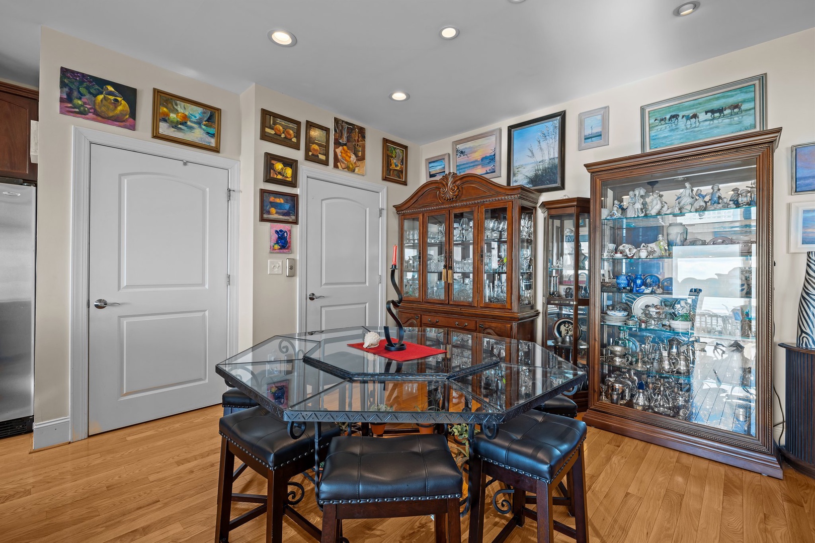 Settle into your elegant dining space surrounded by beautiful artwork and charming display cabinets filled with treasures.