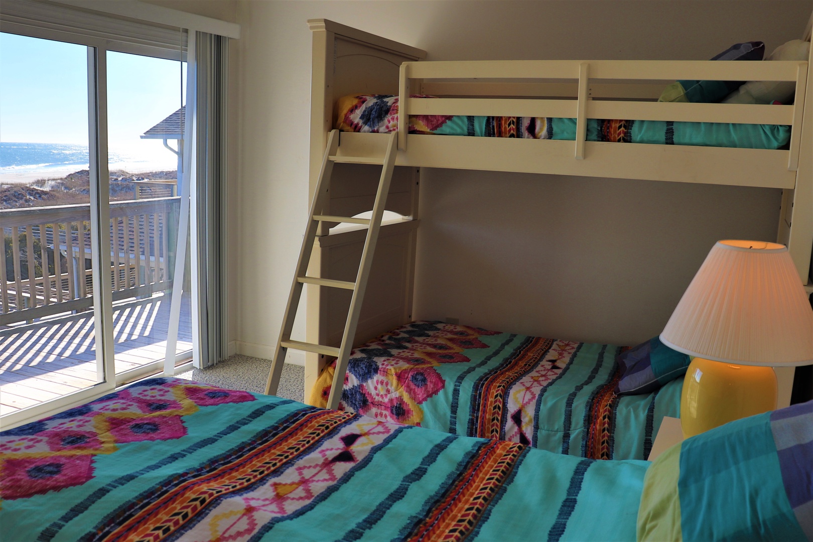 Your family will love this bright bedroom with colorful bedding and stunning ocean views from your private balcony.