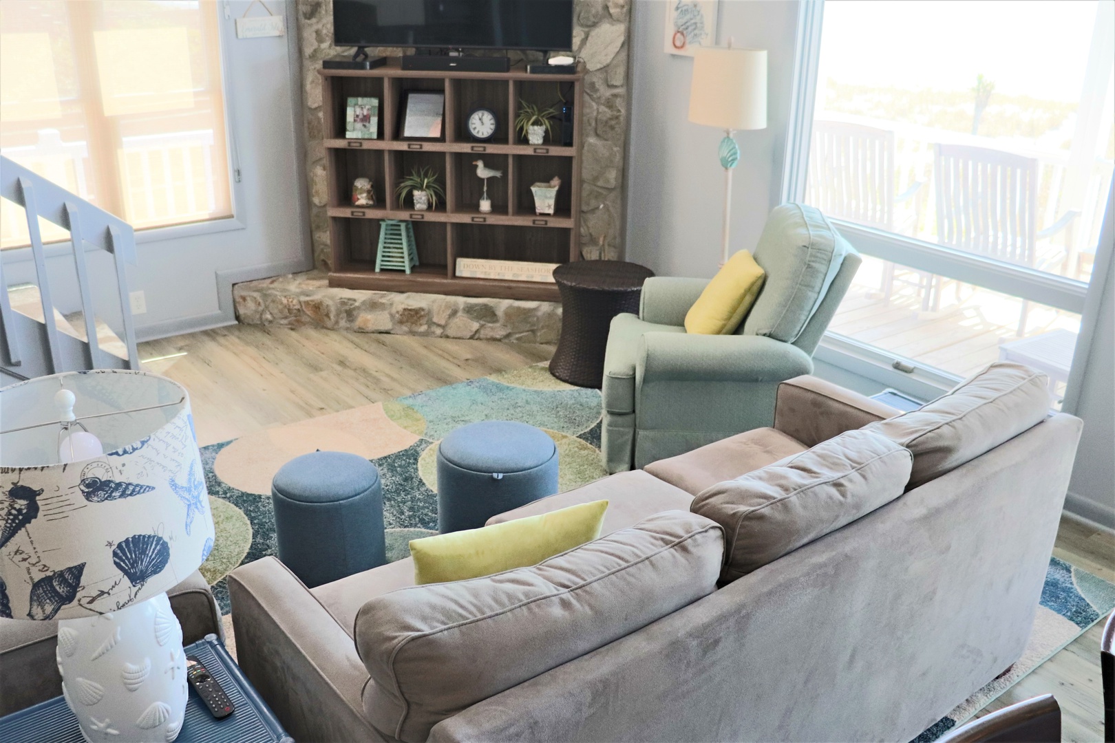 Your stylish living room features plush seating, a stone fireplace, and bright windows creating the perfect space to unwind.