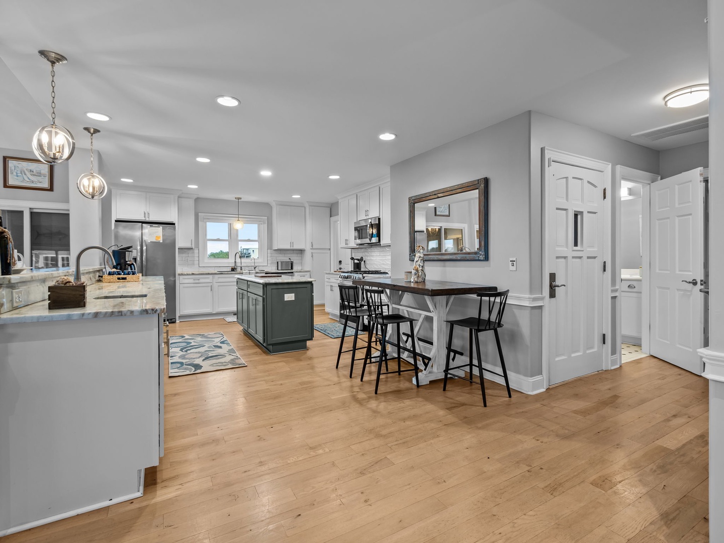Your spacious kitchen invites culinary adventures with gleaming countertops, modern appliances, and a cozy breakfast bar perfect for morning coffee.