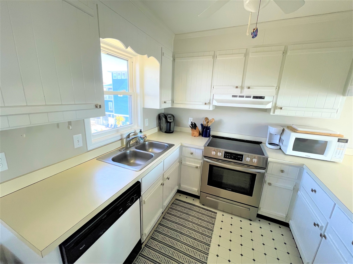 Your fully equipped kitchen awaits with modern appliances, ample counter space, and bright natural light streaming through the charming window—perfect for preparing meals during your stay.