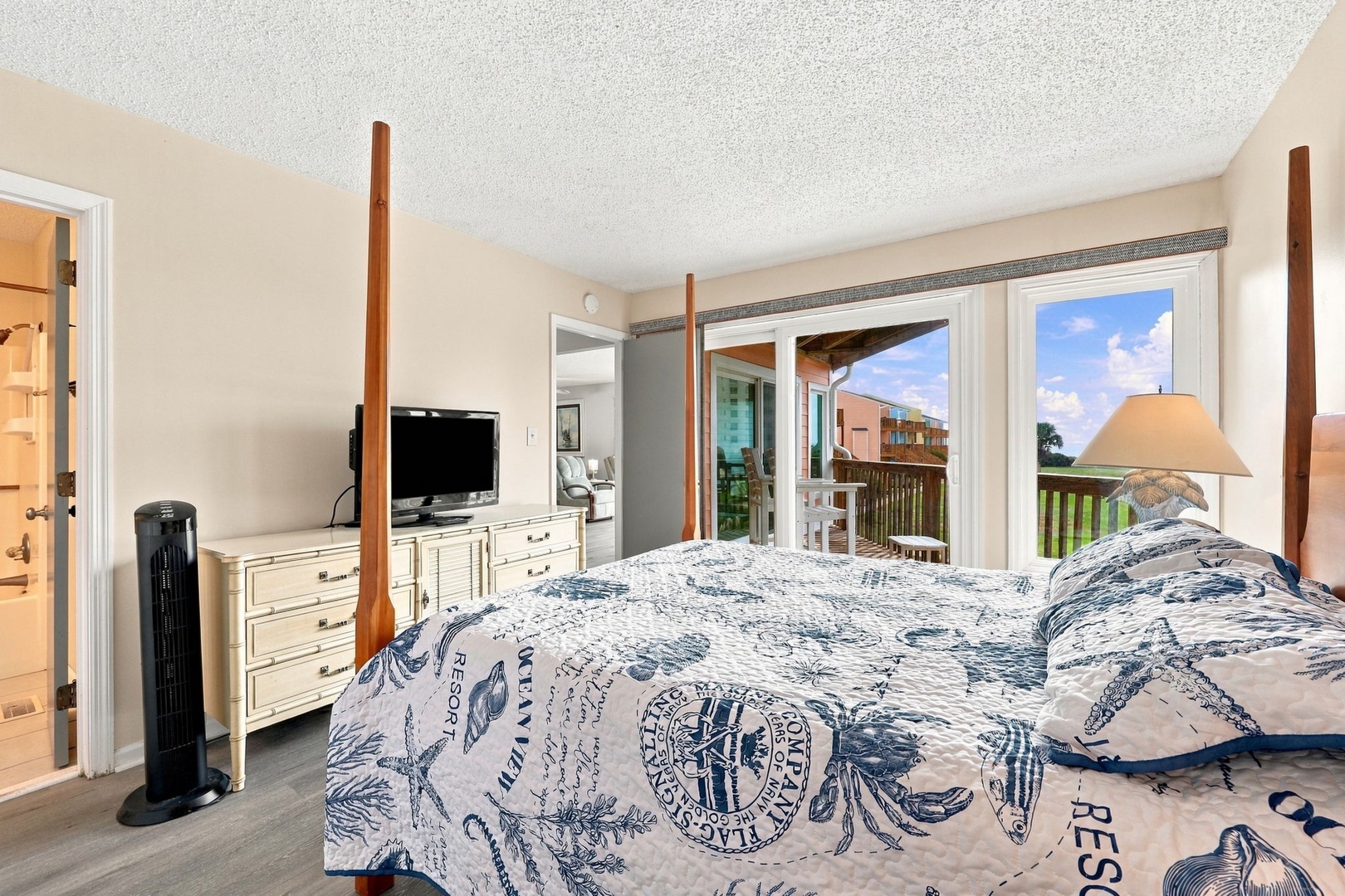Relax in your tranquil bedroom retreat, featuring a plush four-poster bed and large windows framing tropical views. Step onto your private balcony to enjoy sunshine and gentle breezes.