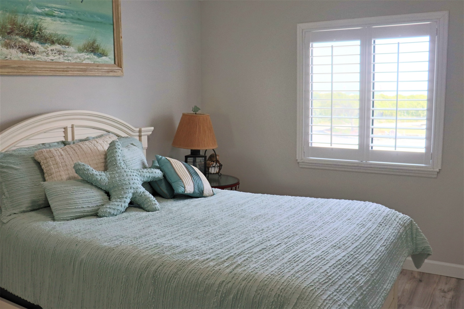 Drift off to sleep in this serene coastal-themed bedroom, where soft sea-green linens and gentle natural light create your perfect seaside retreat.