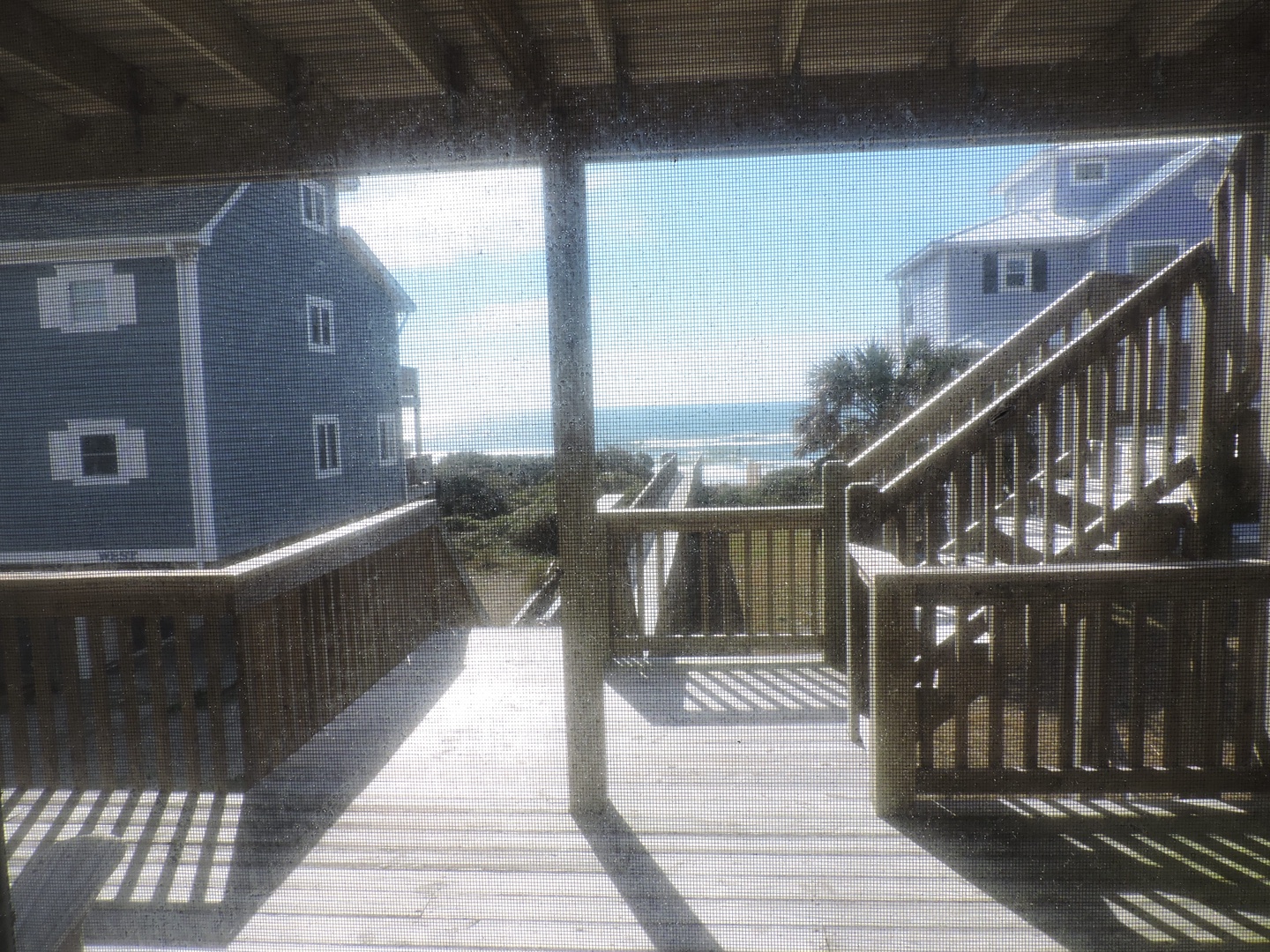 Step onto your private deck and breathe in the ocean breeze while glimpsing the sparkling sea beyond neighboring homes.