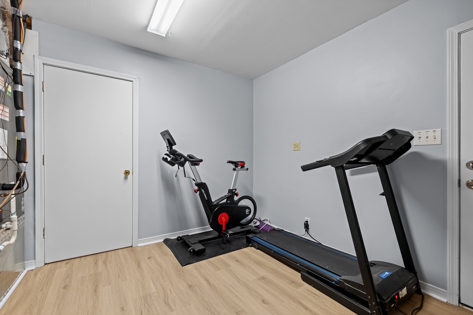 Your private fitness space awaits with a treadmill and stationary bike, perfect for maintaining your workout routine during your stay.