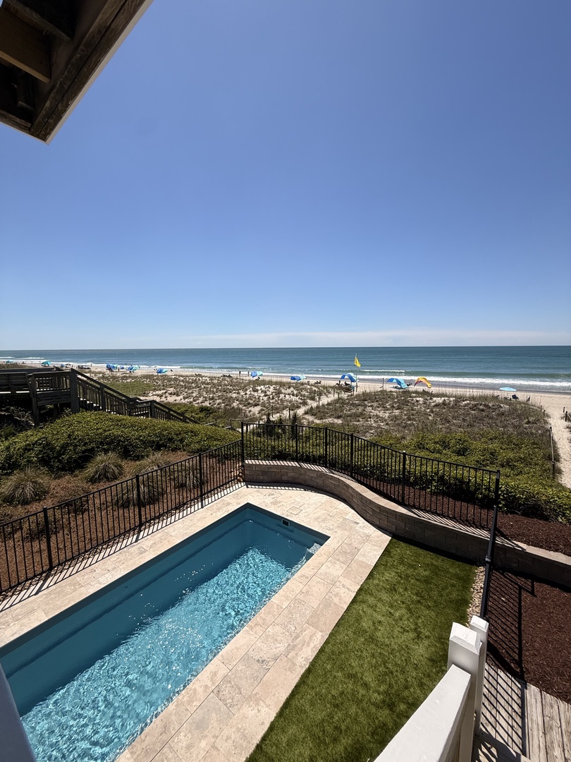 The property features a private pool just steps from a beautiful beachfront location with direct access to the shore and stunning ocean views.