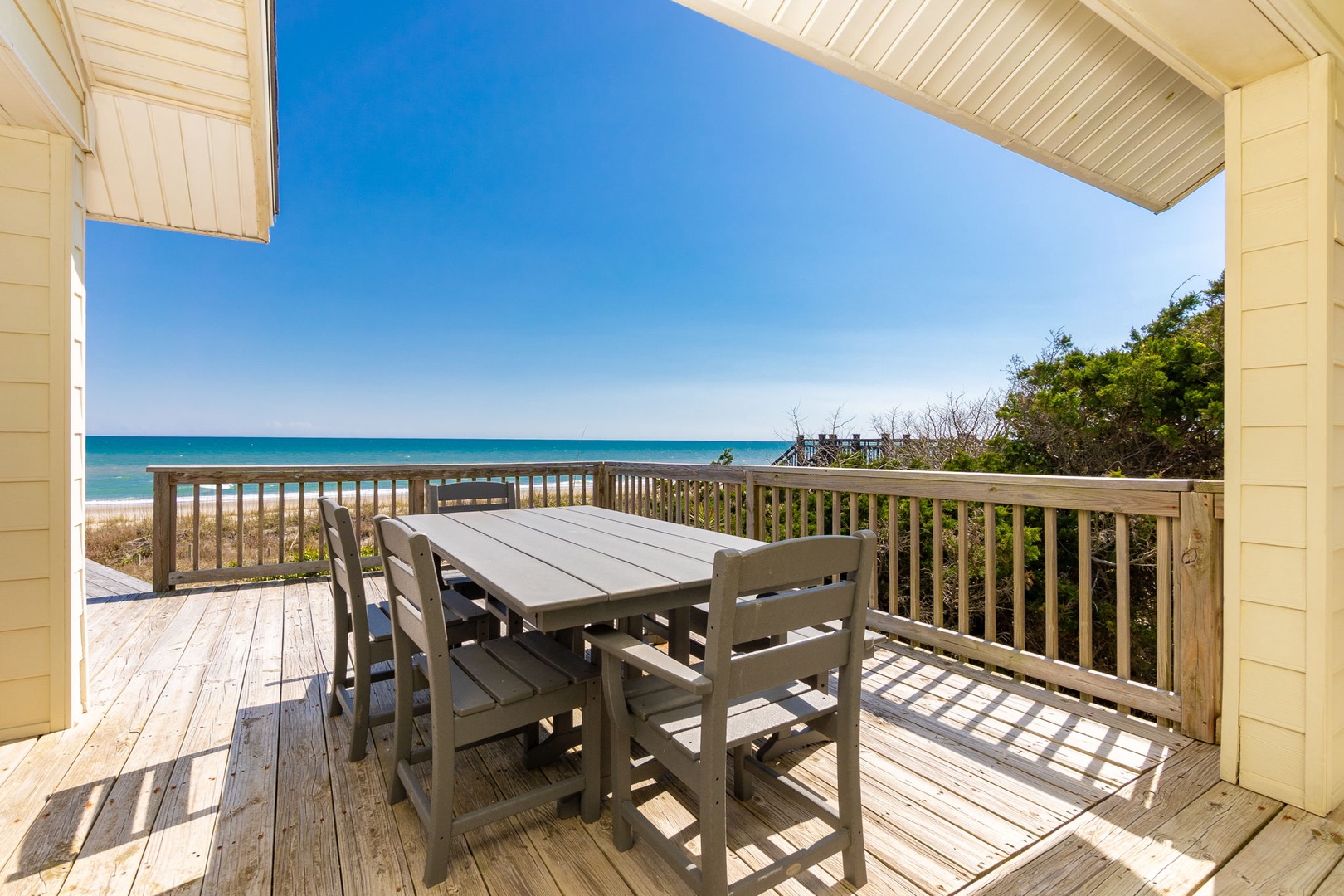 Enjoy morning coffee and evening meals on your private deck with stunning ocean views just steps from pristine white sand.