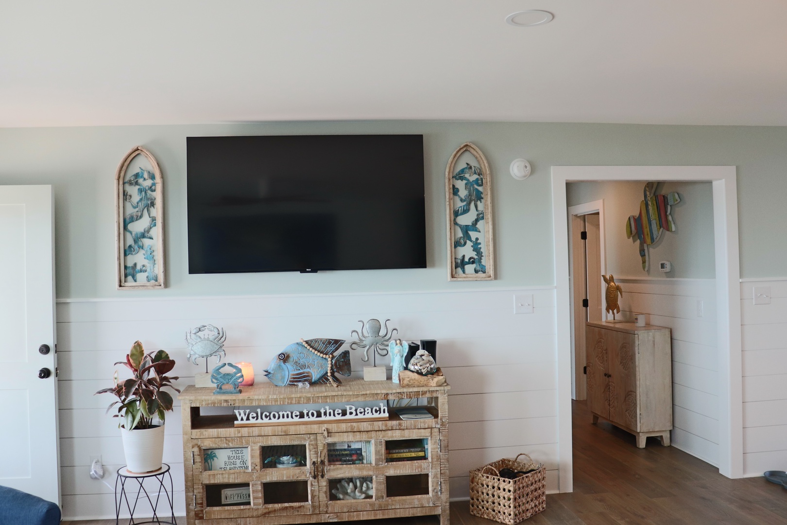 Unwind in your coastal-inspired living room with beachy decor and flat-screen TV for relaxing evenings.