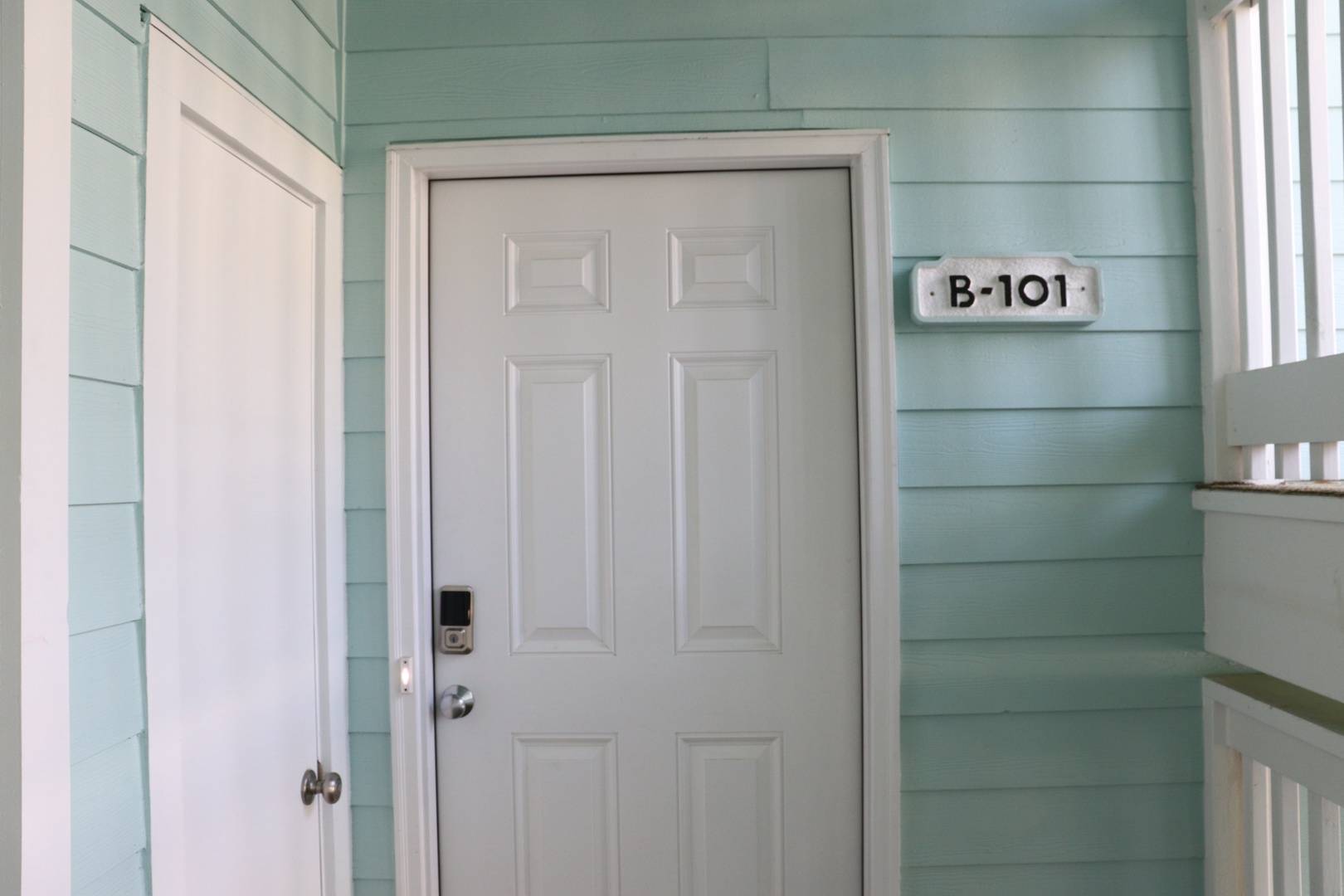 Your charming retreat awaits behind this welcoming door, where coastal-inspired seafoam walls create a peaceful sanctuary for your getaway.