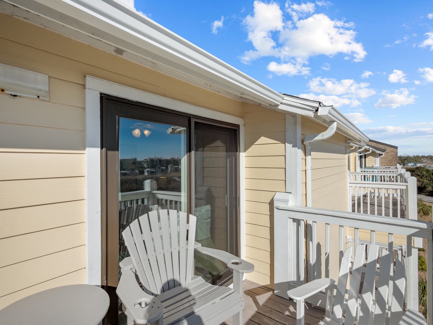 Relax in your classic Adirondack chair on this peaceful balcony, where you can unwind with morning coffee while enjoying the neighborhood views.