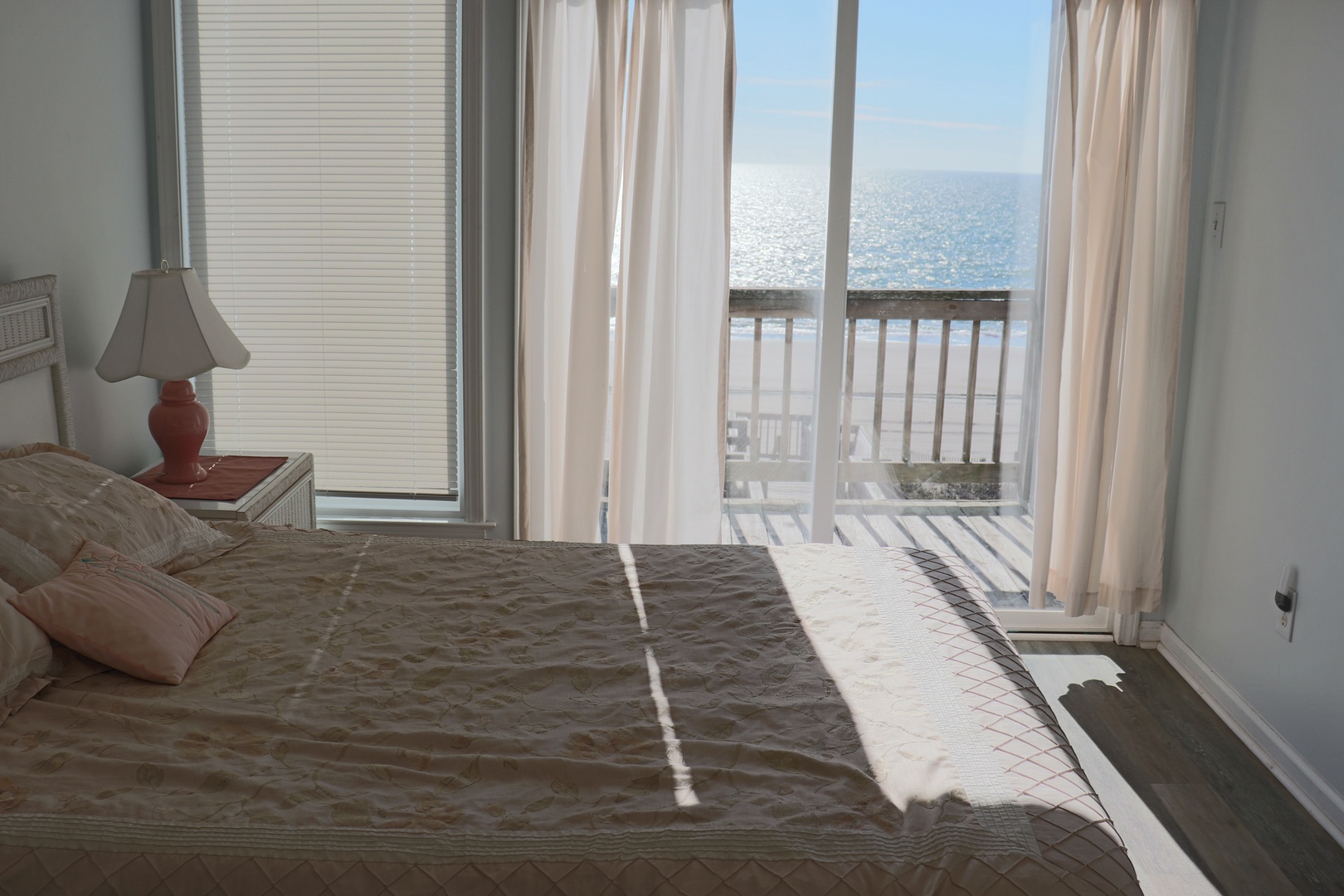Wake up to ocean waves greeting you through your private balcony doors, where soft curtains frame endless sea views.