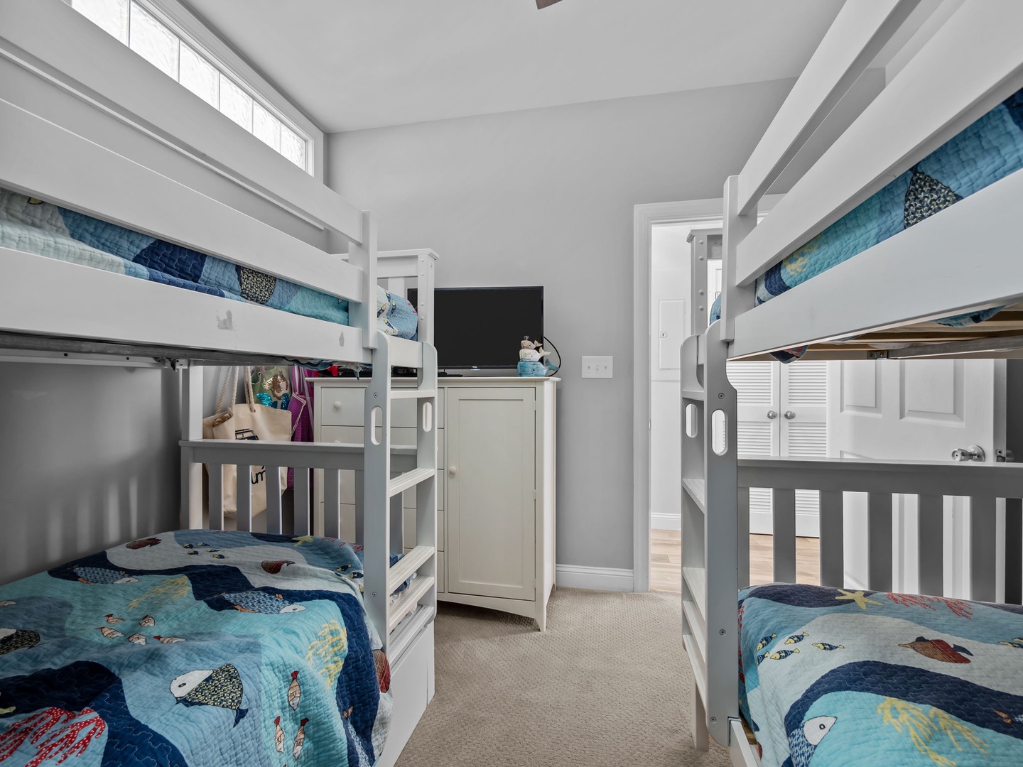 Your kids will love this cozy bunk room with playful ocean-themed bedding and plenty of space for fun adventures together.