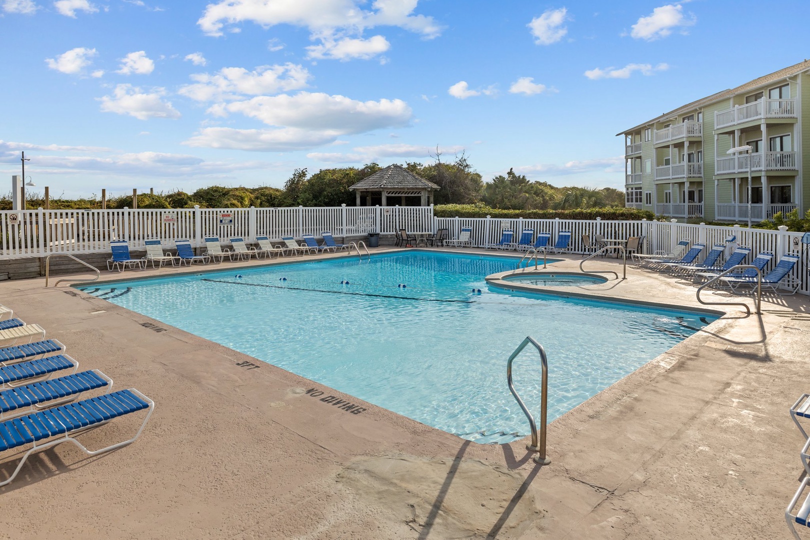 Dive into crystal-clear waters at your private poolside retreat, where sunny days and comfortable loungers create perfect vacation moments.