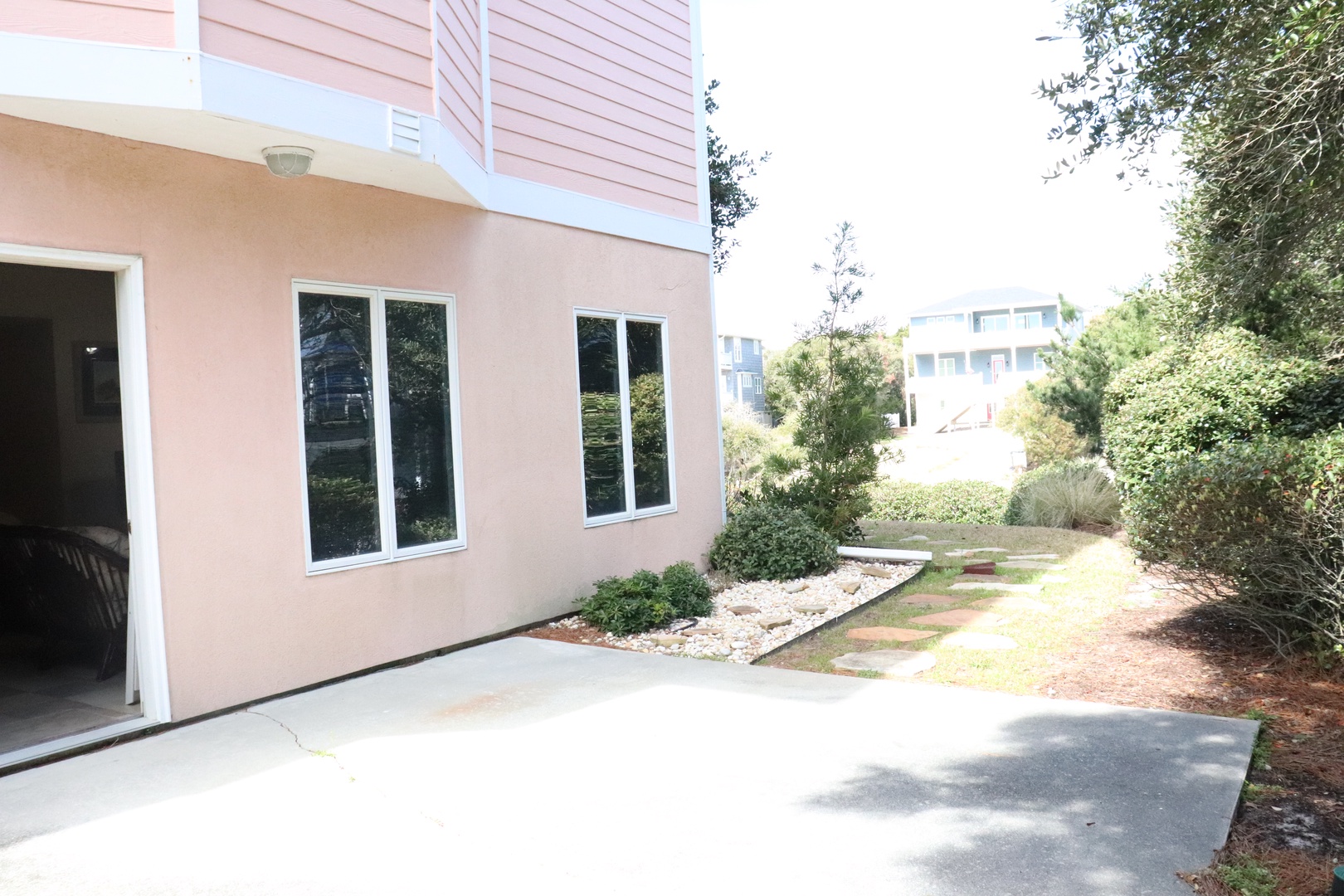 Modern rental property featuring stylish architecture with thoughtfully landscaped gardens and convenient paved pathways in a peaceful residential neighborhood.