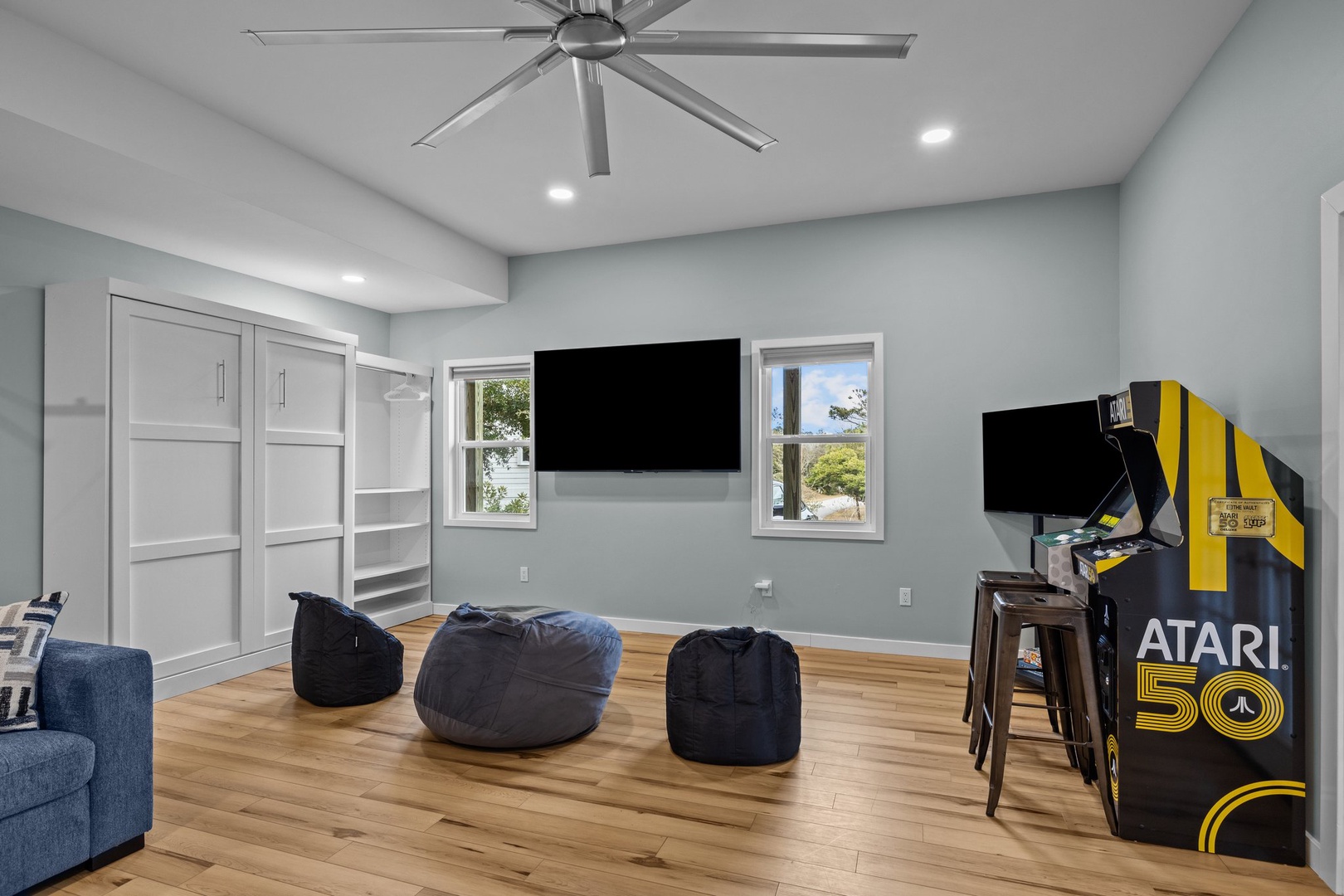 Sink into bean bags and enjoy movie nights or classic arcade games in your entertainment haven with soaring ceilings and natural light.