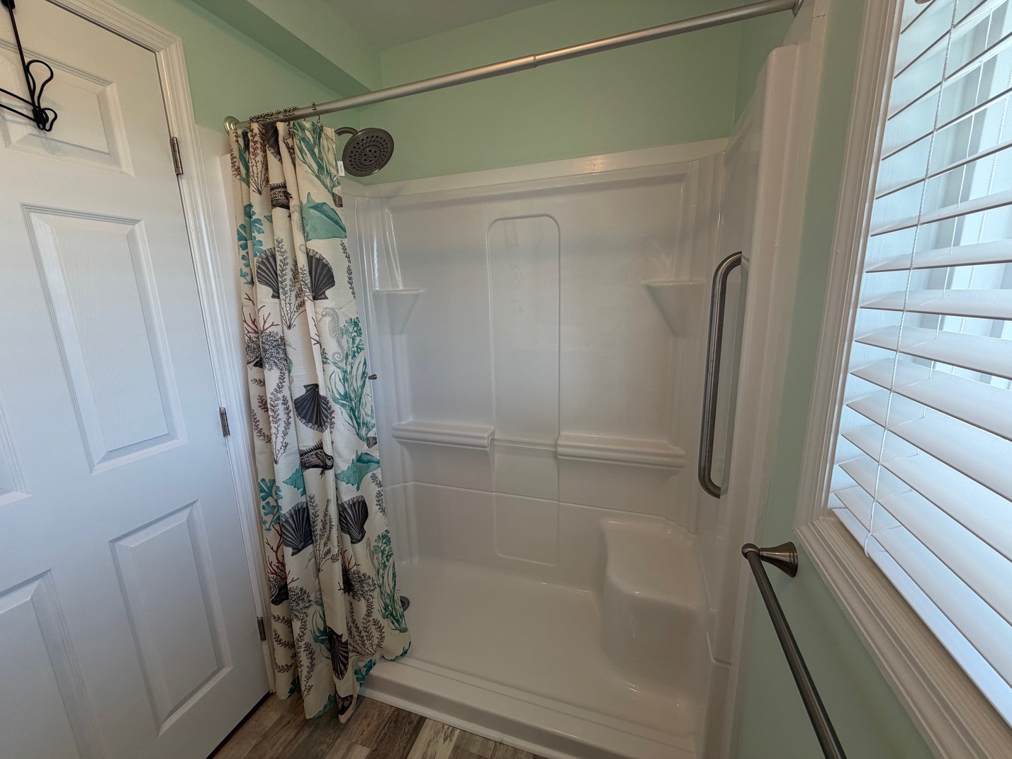Step into your private shower sanctuary with tropical curtains and convenient grab bars for safety and comfort during your stay.