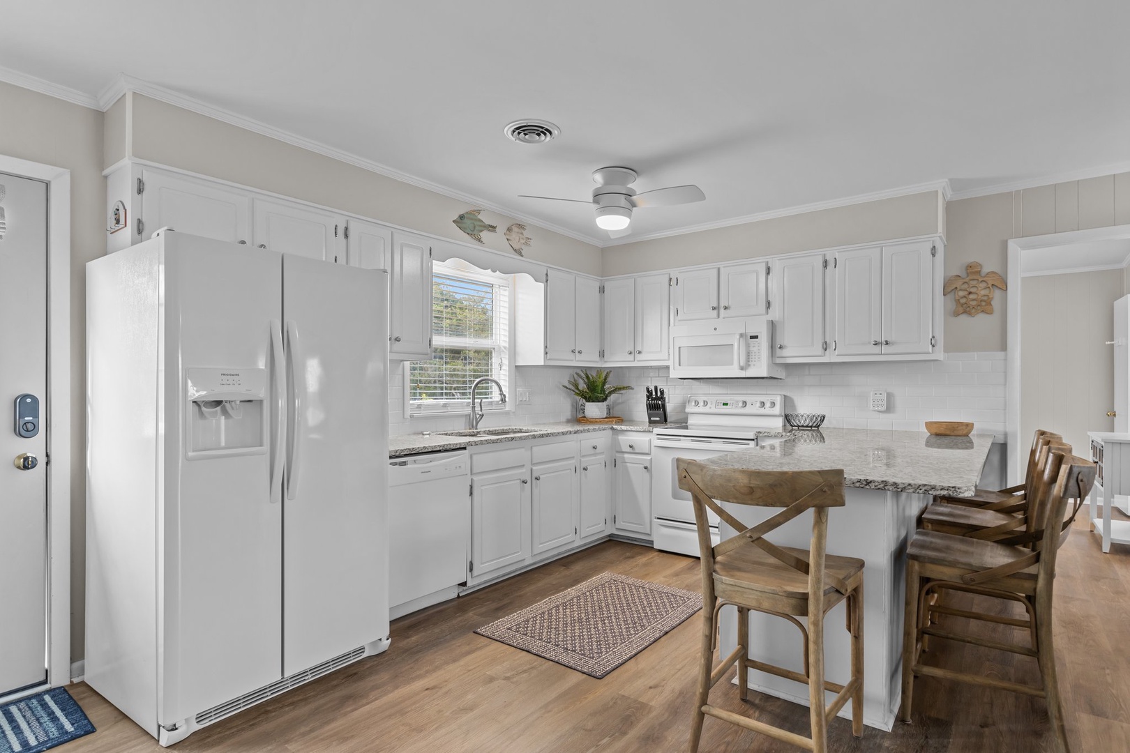 Cook with ease in this bright, fully equipped kitchen featuring modern appliances and a convenient island for your meal prep.