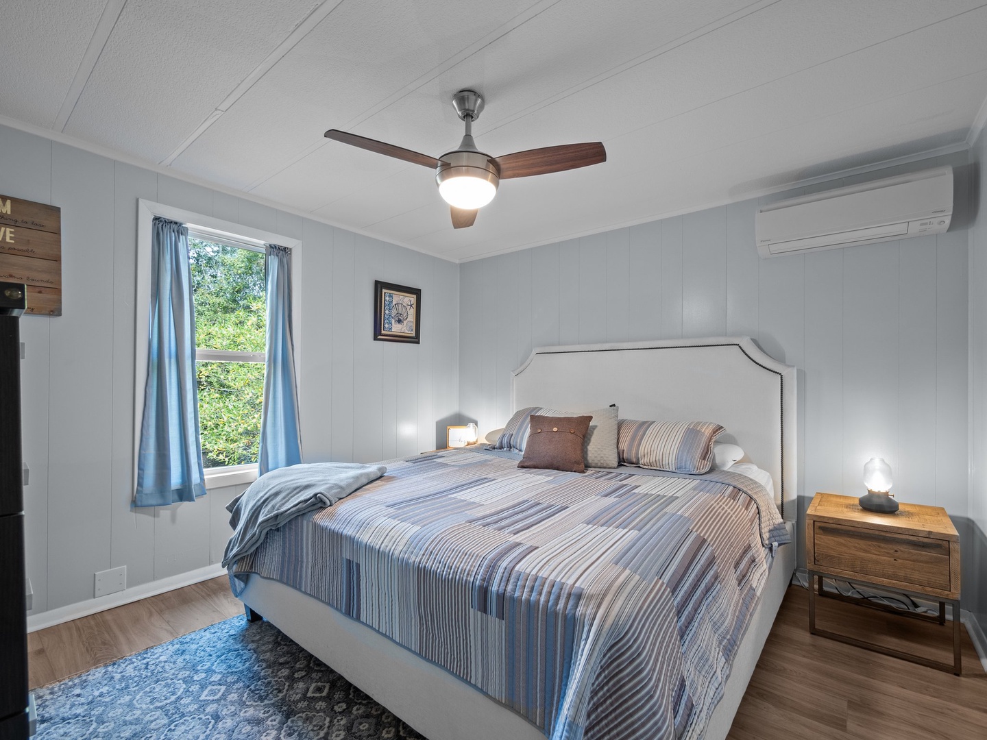 Your peaceful bedroom awaits with soft natural light, cooling ceiling fan, and comfort for restful nights.
