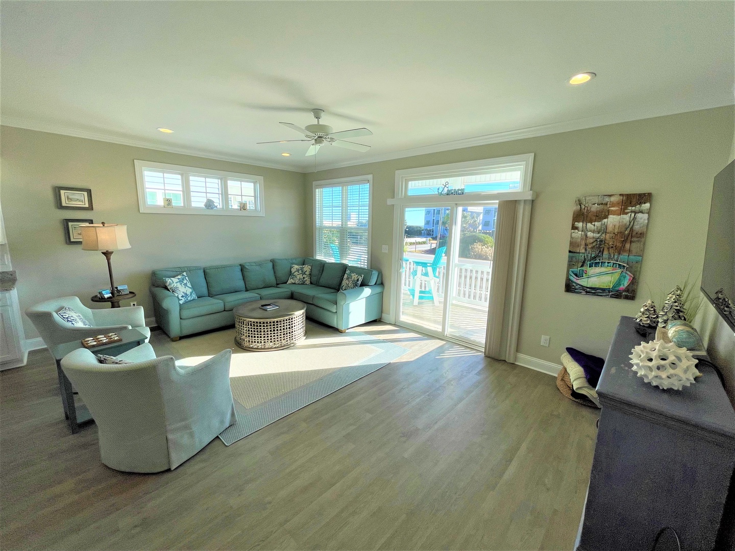 Unwind in your bright coastal living room featuring plush seating and stunning ocean views through sliding glass doors leading to your private balcony.