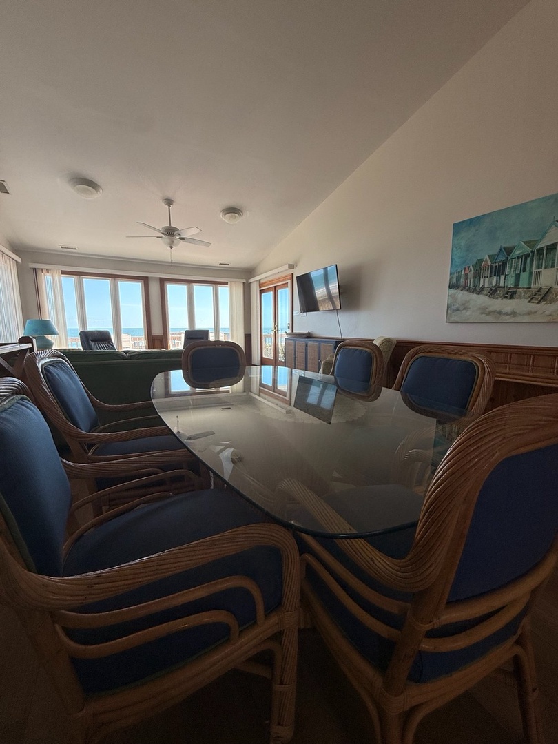 Gather around the elegant dining table where ocean breezes drift through the balcony doors and endless sea views frame every meal. Your perfect beach getaway starts here.