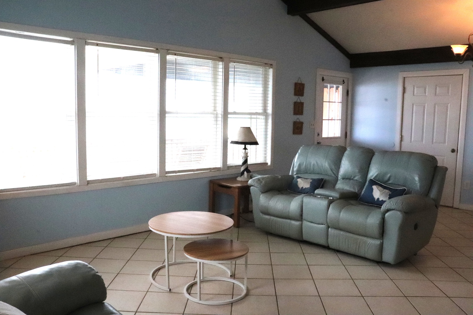 Settle into your comfortable living space with soft seating, natural light, and coastal charm welcoming you home after a day of adventure.