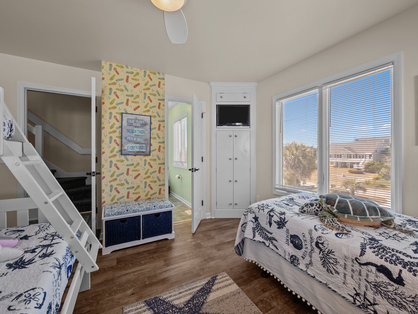 Your kids will love this cheerful bedroom with bunk beds and twin bed, plus built-in storage and TV for cozy nights.