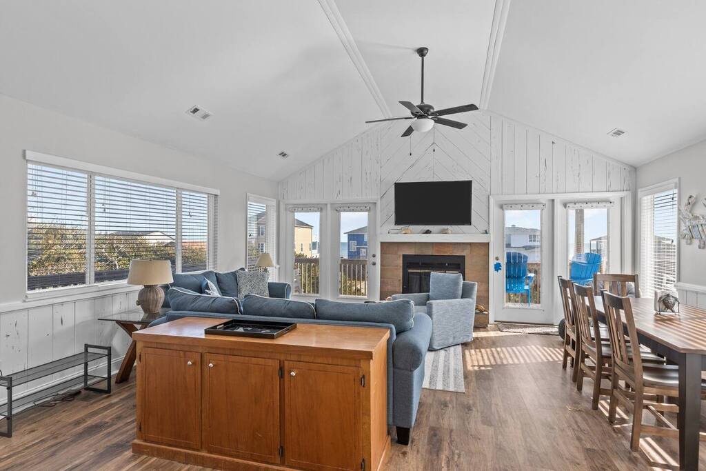 Relax in your bright, airy living space with soaring ceilings and cozy fireplace, perfect for unwinding after beach adventures.