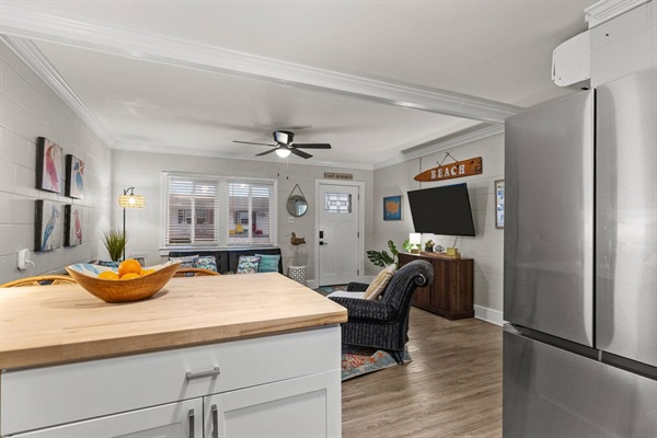 Unwind in your bright, modern living space with sleek kitchen island, cozy seating, and everything you need for a perfect stay.