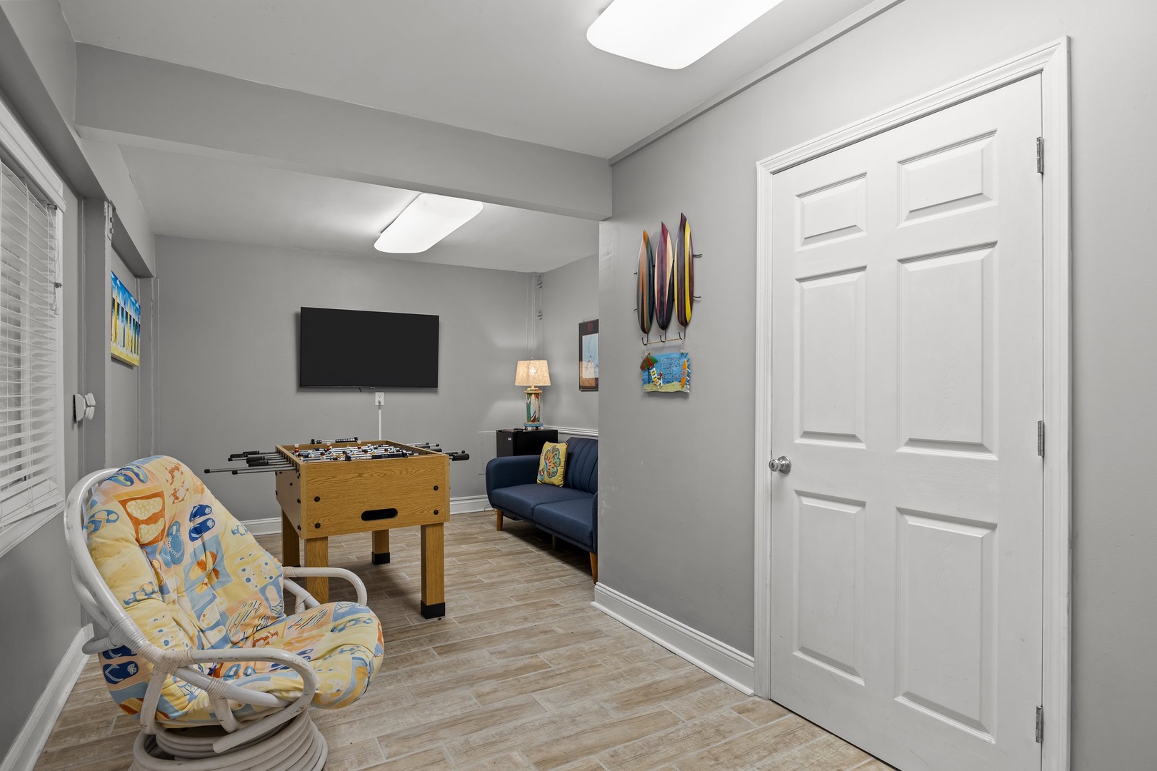 Unwind in your private game room with foosball table, cozy seating, and TV for endless entertainment during downtime.