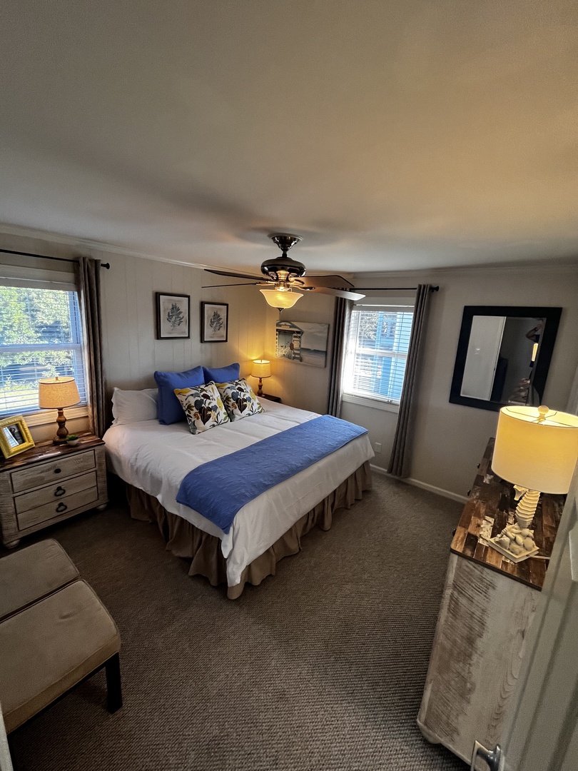 Your cozy bedroom features a plush bed with vibrant blue accents and soft lighting to help you unwind after a day of exploring.