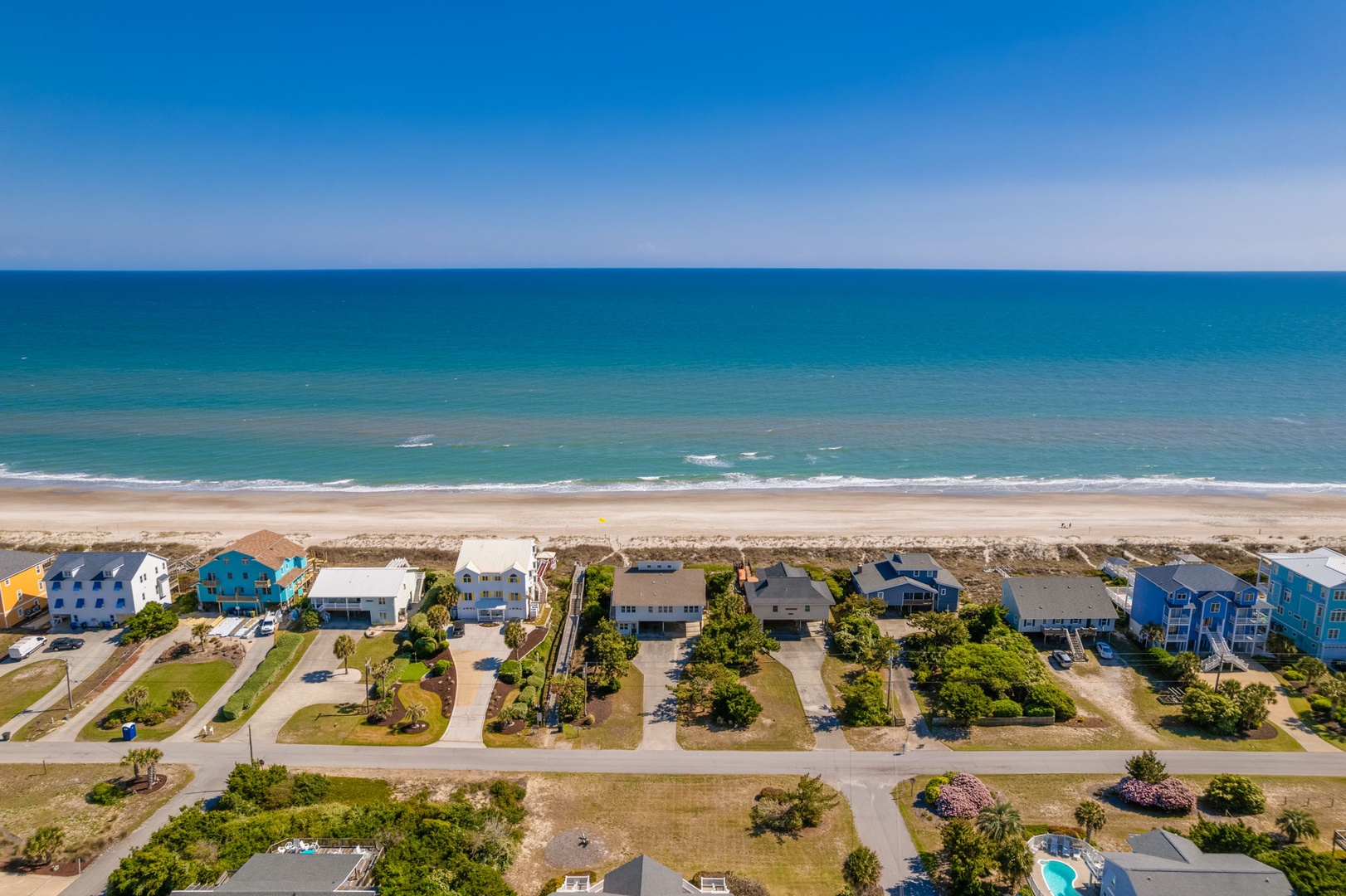 Stunning beachfront community with colorful coastal homes just steps from pristine sandy shores and turquoise waters.